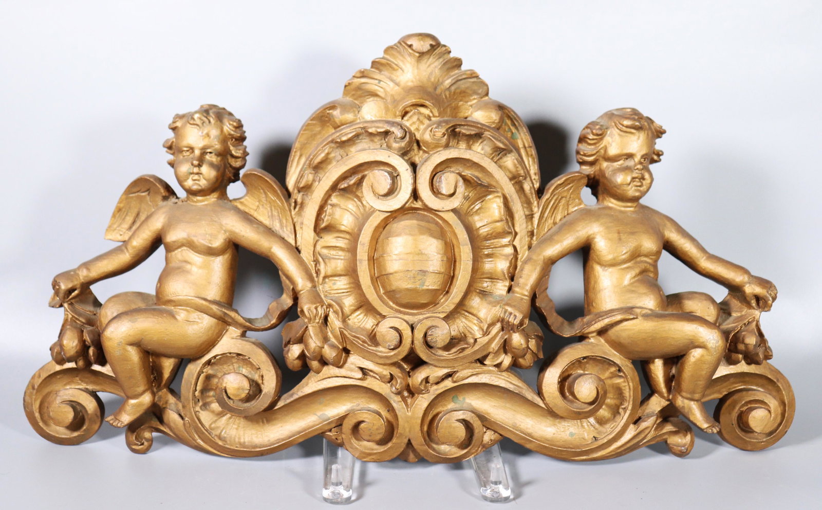 European Carved Gilt Wood Baroque Cupid Crest: European Carved and Gilt Wood Baroque Cupid Crest. Height 11 7/8 inches (30.2 cm.) X width 21 3/4 inches (55.2 cm.). PROVENANCE: From a North Shore Long Island Family Collection