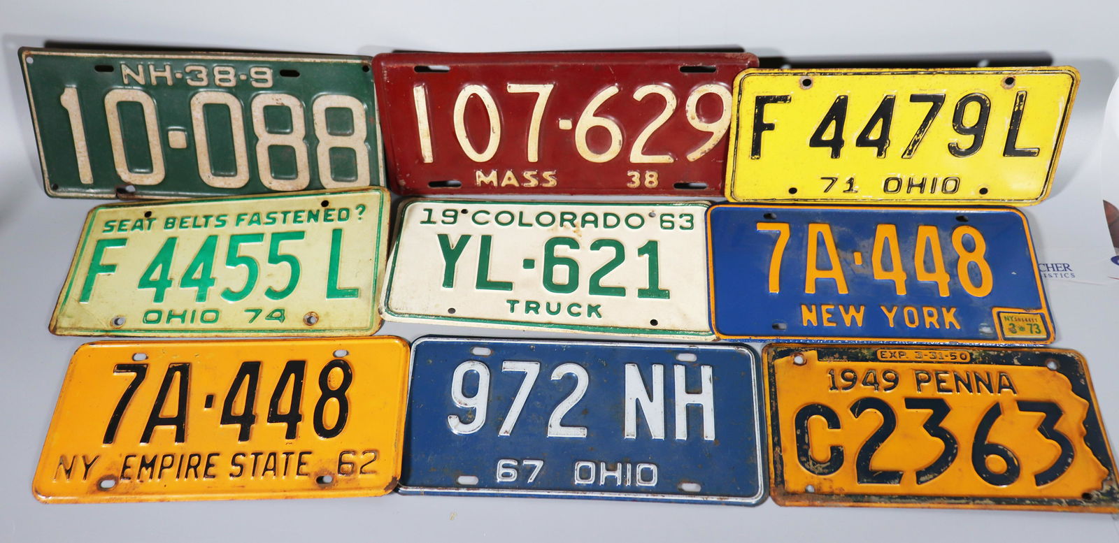 9 US Automobile License Plates 1938-1974: 9 US Automobile License Plates: Massachusetts 1938, New Hampshire 1938-39, Pennsylvania 1949-50, New York "Empire State" 1962, Colorado Truck 1963, Ohio 1967, Ohio 1971, New York 1973, Ohio "Seat Belt