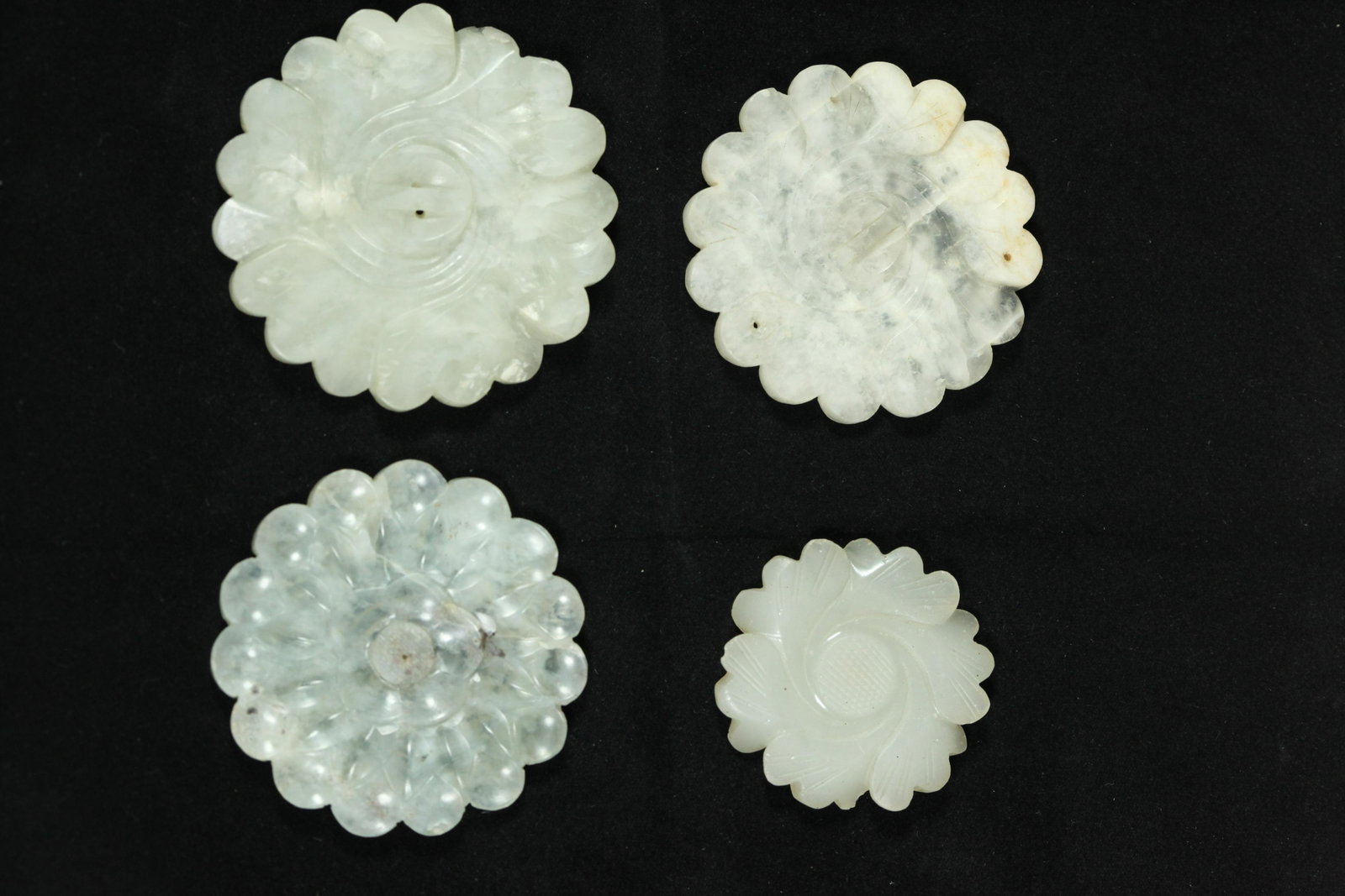4 Lg Chinese Ming Hardstone 1 Glass Buttons: 4 Large Chinese Ming Dynasty or early Qing Jade Geometric Floral Center Buttons in Jade, Hardstone and 1 in rare "jade-colored" Peking Glass. Diameter of largest 2 1/2 inches (6.4 cm.). PROVENANCE: Th