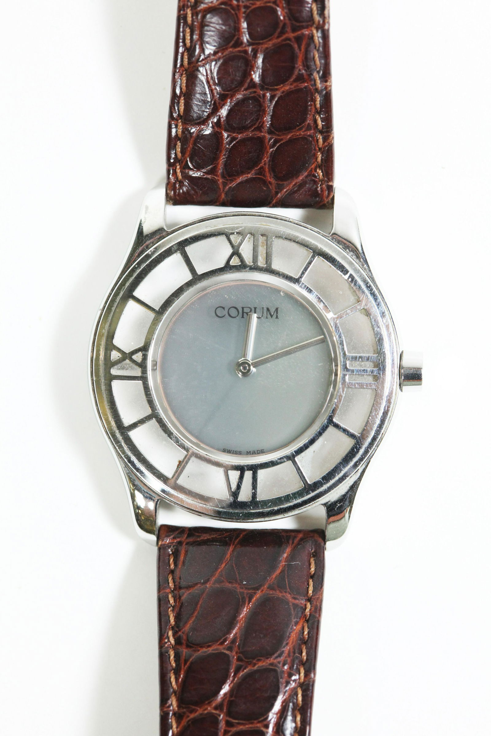 Corum "Mystery" Roman Numeral Wristwatch: Corum Mystery Swiss Water Resistant Wristwatch with Roman Numerals,138.500.20 Stainless Steel, Corum alligator leather strap with Corum Logo steel buckle. Numbered 666890 to back Approximate diameter