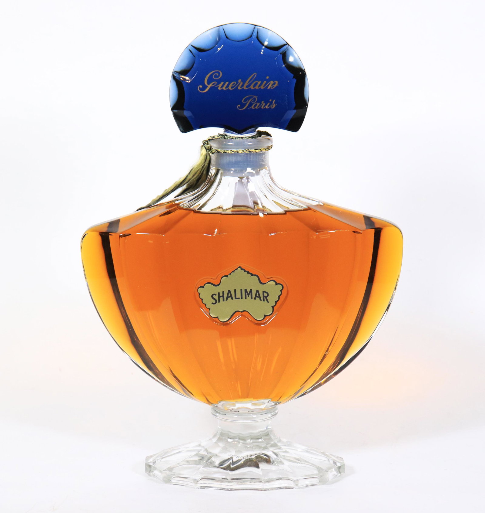 Shalimar, Guerlain Paris; 14 3/4 Inch Bottle: Shalimar, Guerlain Paris Bottle sealed and unopened; molded mark to glass base, "GUERLAIN PARIS HP." Height 14 3/4 inches (37.5 cm.).