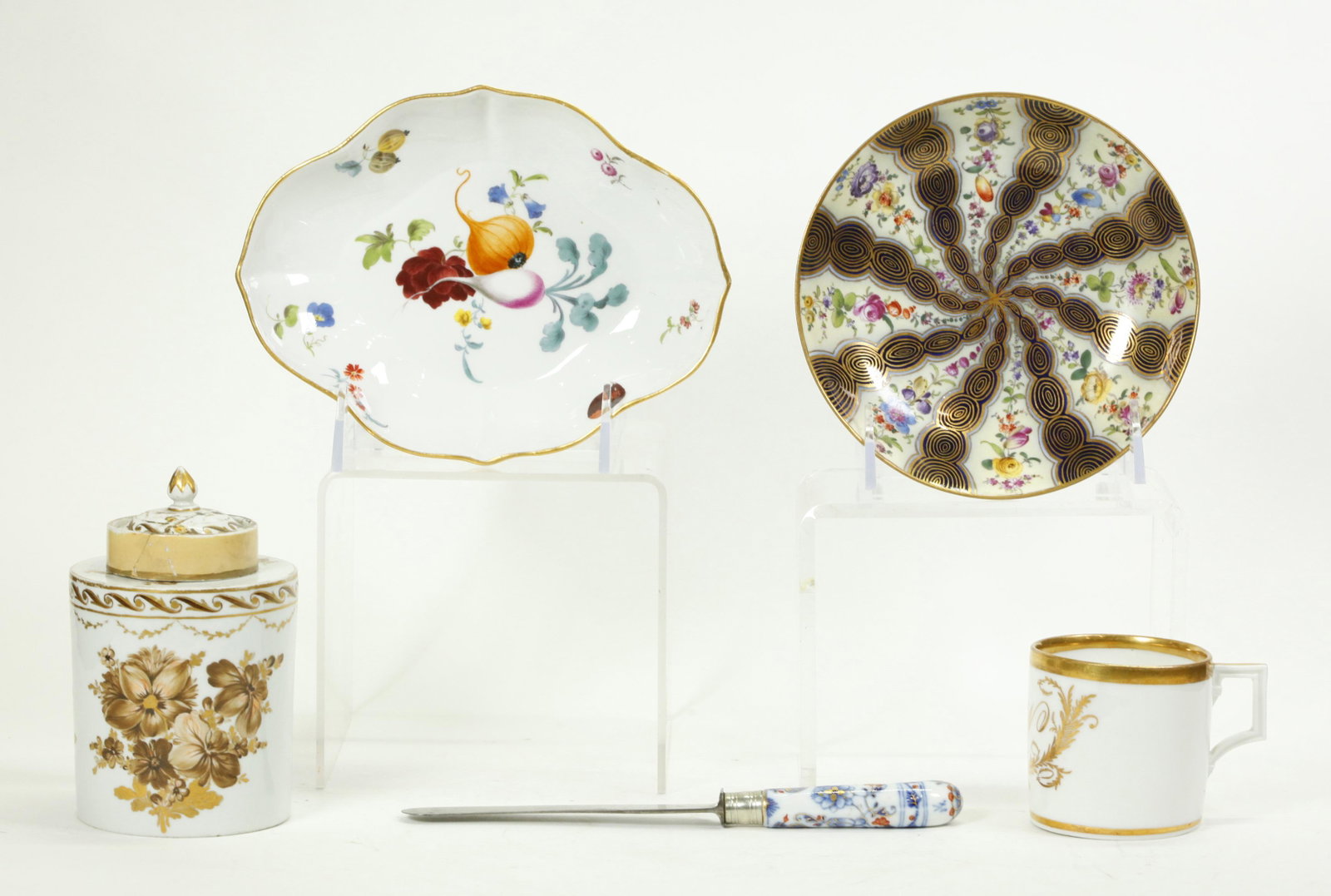 4 Meissen 18 Early 19 C Porcelains; 1 Furstenberg: 4 Meissen 18 or Early 19 Century Porcelains: a Quatrefoil low bowl with fruit & flowers and underglaze blue crossed swords with dot to base, a single handle coffee cup with initial "W" in gold and cro