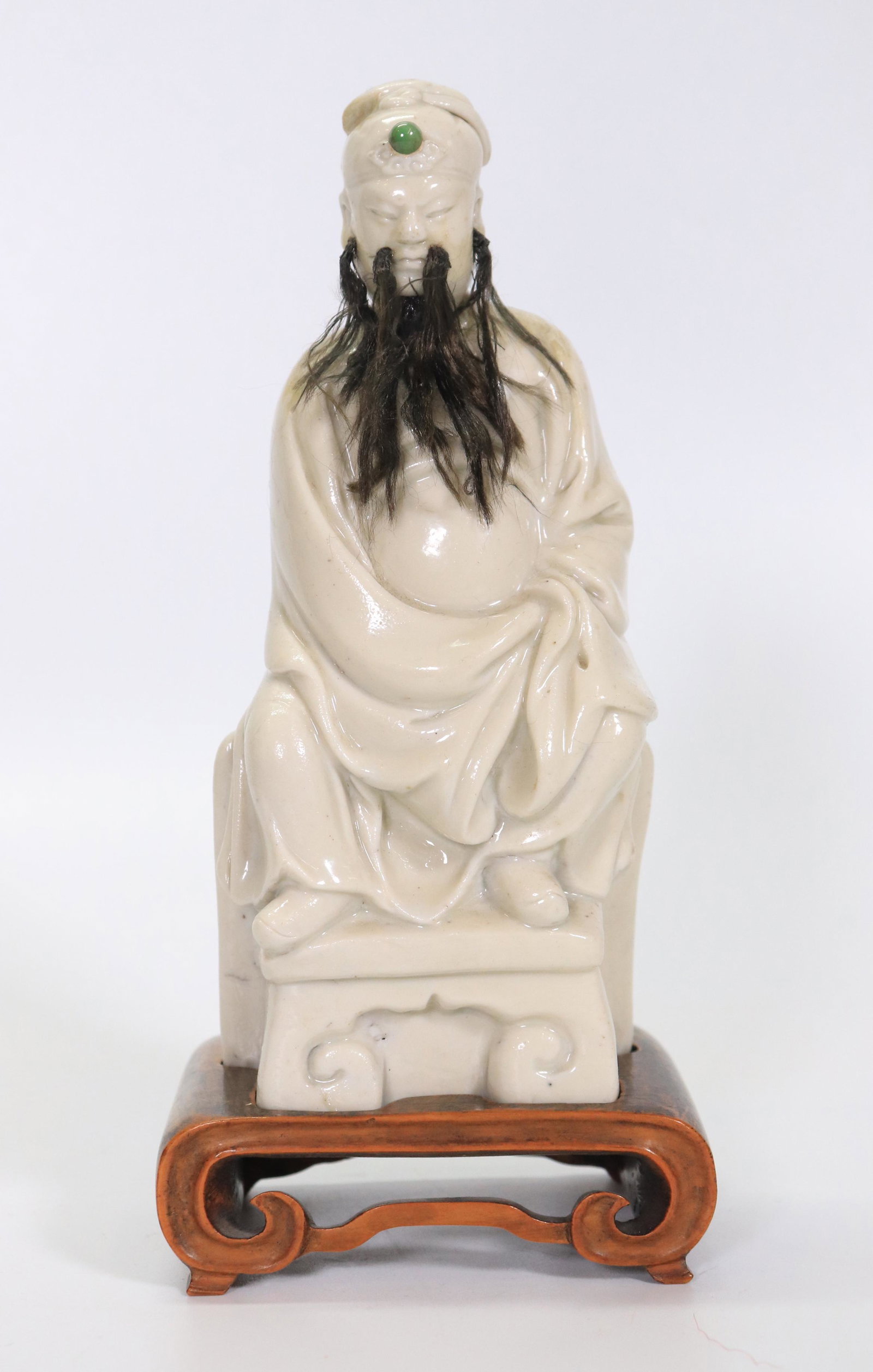 Chinese 17 C Blanc de Chine Porcelain Daoist God: Chinese 17 Century Blanc de Chine Porcelain Seated Daoist God, probably Wenchang God of Literature, now with applied moustache and beard and a small green jewel attached to his hat; rectangular light 