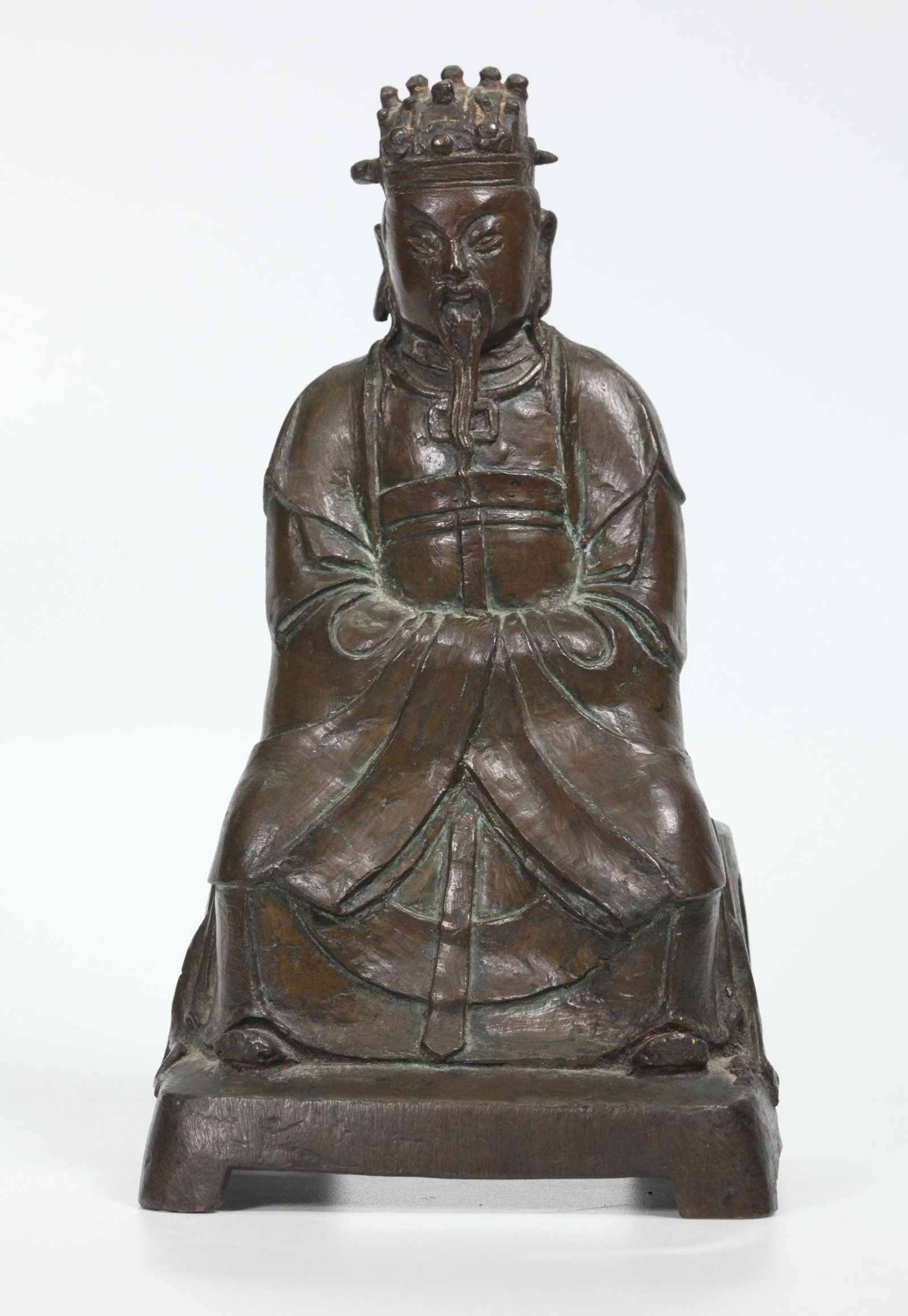 Chinese Ming Dynasty Bronze Seated Daoist God: Chinese Ming Dynasty Bronze Seated Daoist God with elaborate headdress and arms folded inside sleeves. Height 8 1/4 inches (21 cm.).