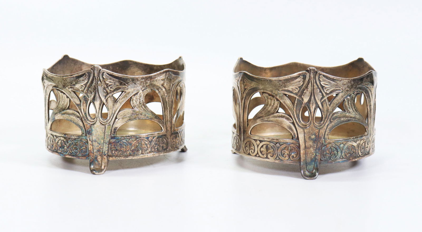Pr Art Nouveau or Jugendstil Silver Wine Coasters: Pair Art Nouveau or Jugendstil Silver Plate Wine Coasters on 3 small feet; marks to bases. Height 3 inches (7.5 cm.) X diameter 4 1/4 inches (10.8 cm.).