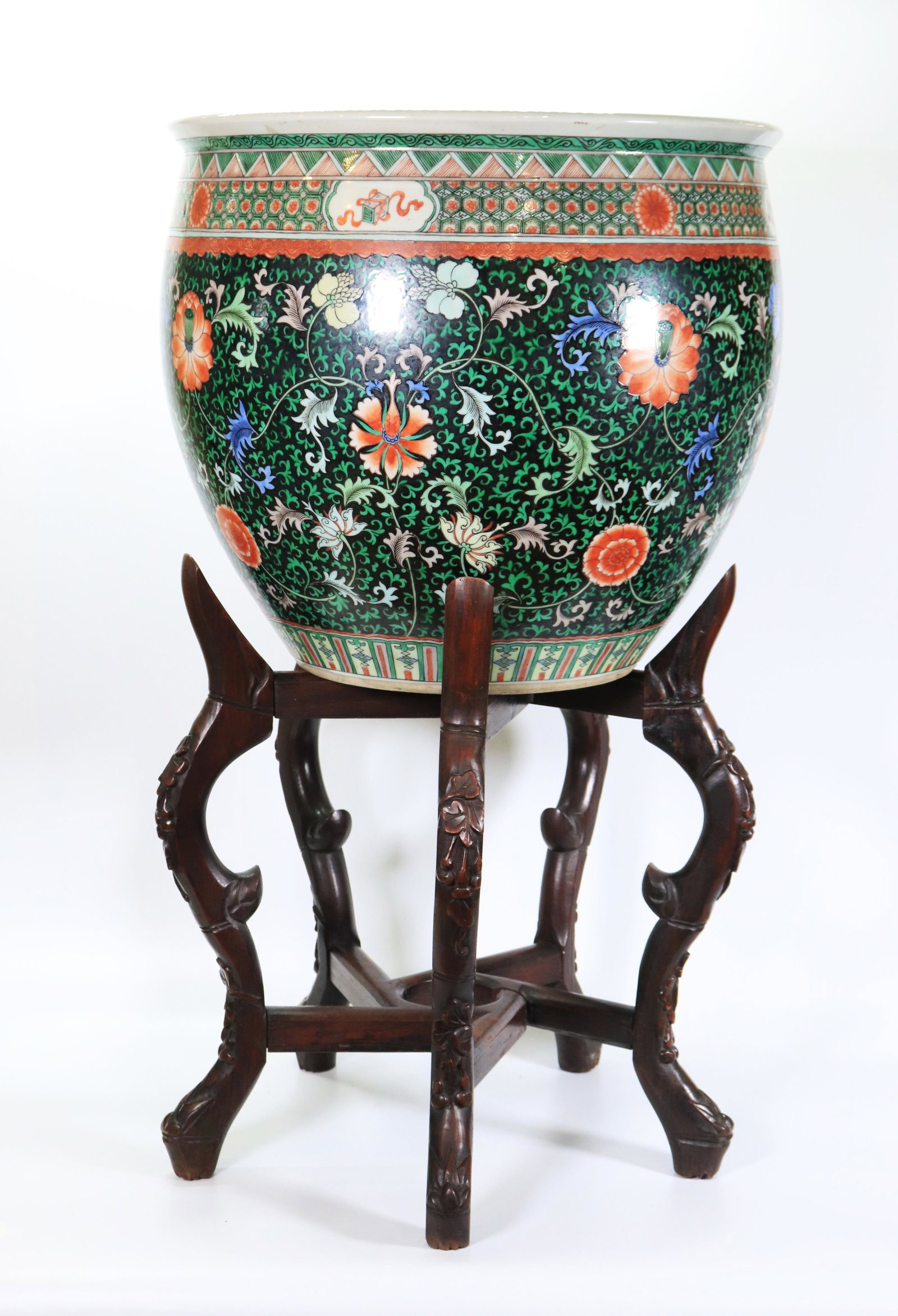 Chinese Famille Noire Enameled Porcelain Fish Bowl: Chinese Famille Noire Enameled Porcelain Fish Bowl with a design of scrolling flowers and leaves on a black ground, brocade Famille Verte borders to top and bottom edge, base unglazed without a hole. 