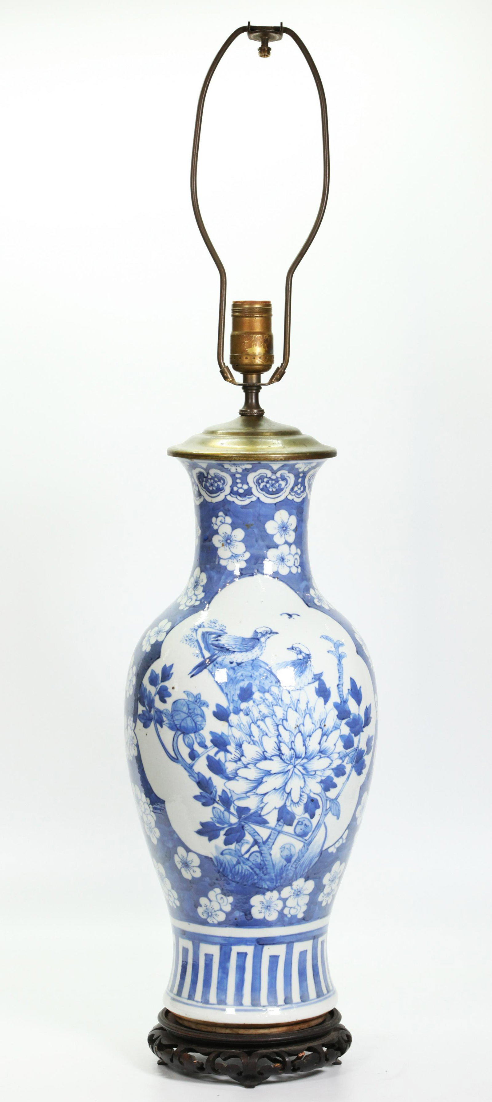 Chinese Blue & White Porcelain Vase: Chinese Blue & White Porcelain Vase with 2 windows with a design of Birds and Peonies surrounded by white flowers on a blue ground; now mounted on a hard wood stand and a metal cover as a lamp. Height