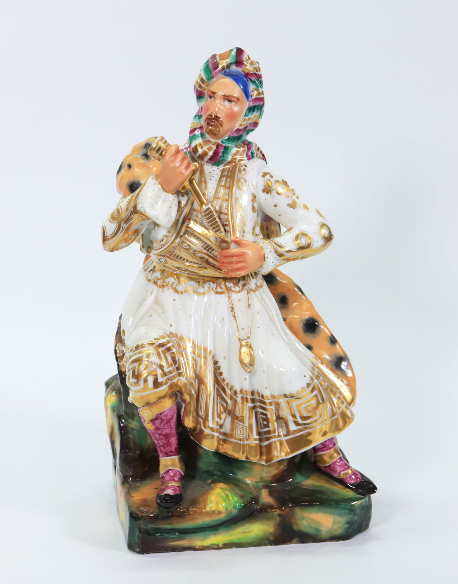 European Porcelain Ottoman Man Teapot & Warmer: European Porcelain Ottoman Man Teapot & Warmer split at the waist into a small teapot filled through the head with the left arm as handle and the hilt of the knife as spout, the rockwork base with an