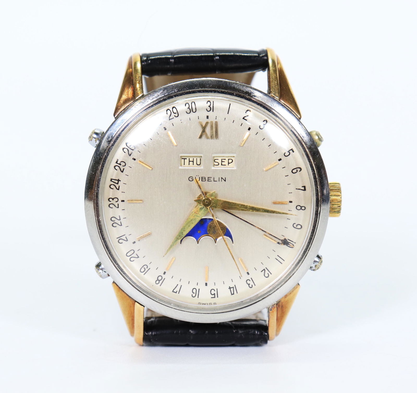 Gubelin Watch Moon-Phase Gilt Steel Gubelin Strap: Gübelin Watch Moon-Phase Day Month; Gübelin Kaufmann Krokodil Strap. Diameter 37.25mm. PROVENANCE: Private Collection of a Manhattan Businessman.