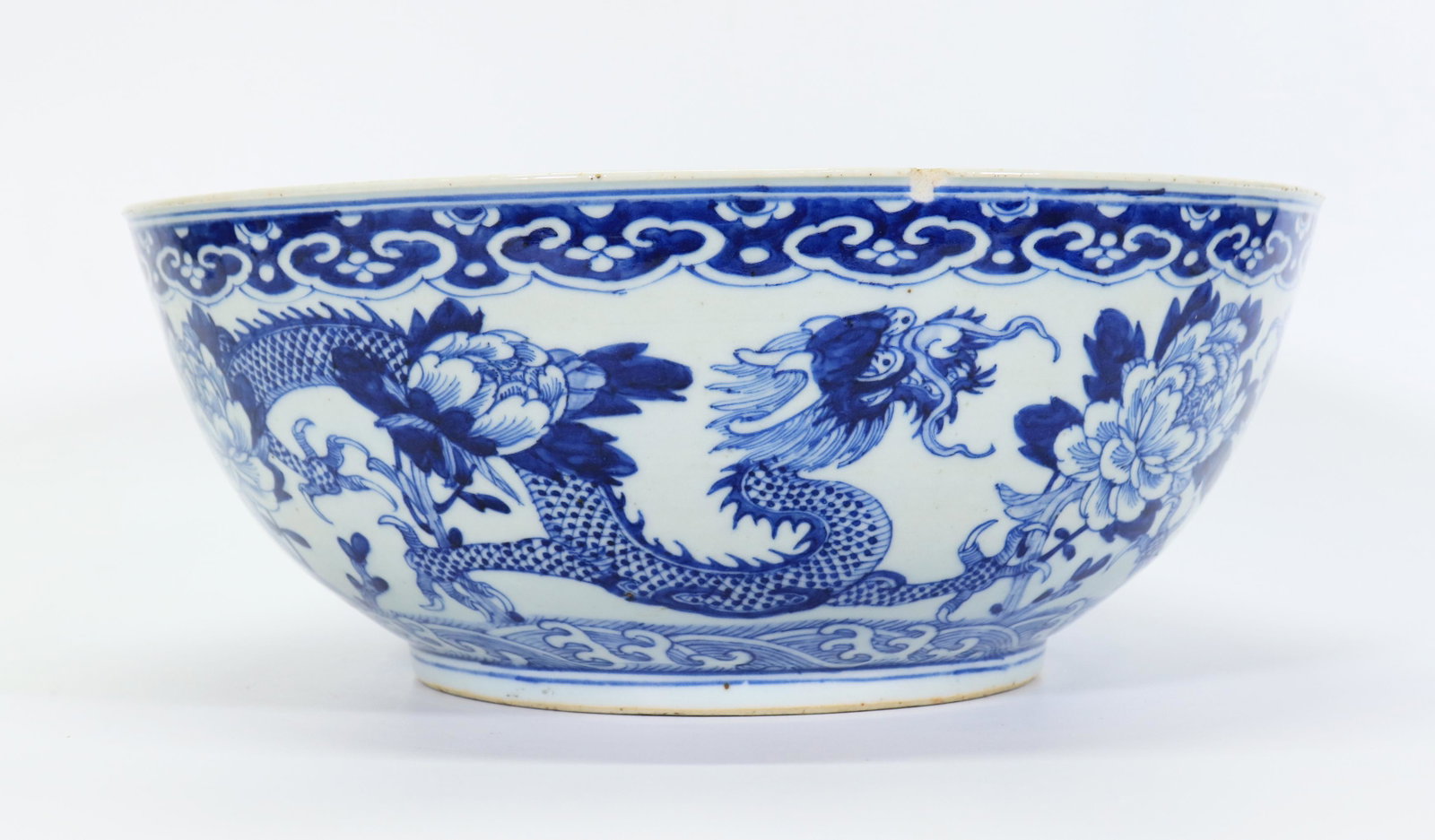 Chinese Blue & White Porcelain Dragon Peony Bowl: Chinese Blue & White Porcelain Bowl of 2 confronting 4-claw Dragons with Peony Flowers over waves, the base with a 4 character Xuande mark in underglaze blue. Diameter 12 1/4 inches (31 cm.).
