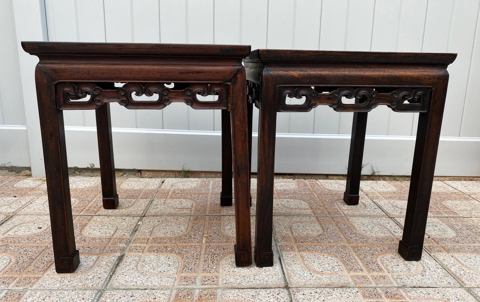 2 Chinese Hard Wood Waisted 4 Legged Tables: 2 Chinese Hard Wood Waisted 4 Legged Tables with pierced and carved aprons under top and curled base feet. Height 20 1/4 inches ( 51.5 cm.) X Square top 17 3/4 inches square (45 cm. square).