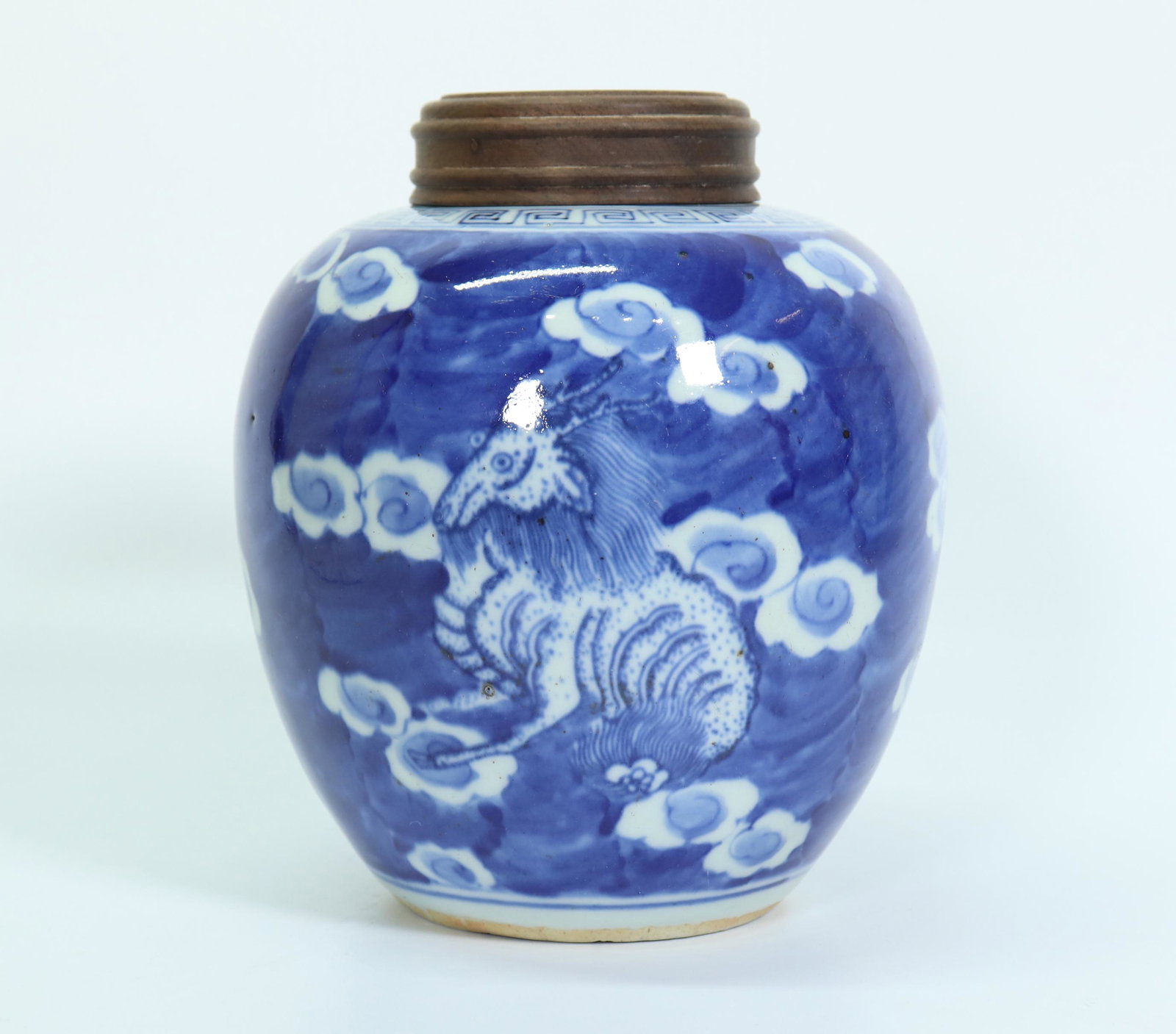 Chinese White & Blue Porcelain Animal Tea Jar: Chinese White & Blue Porcelain Mythological Animal Tea Jar, the 3 horned animals painted with white clouds on a blue ground; hard wood cover. Height of jar only 5 3/4 inches (14.5 cm.).