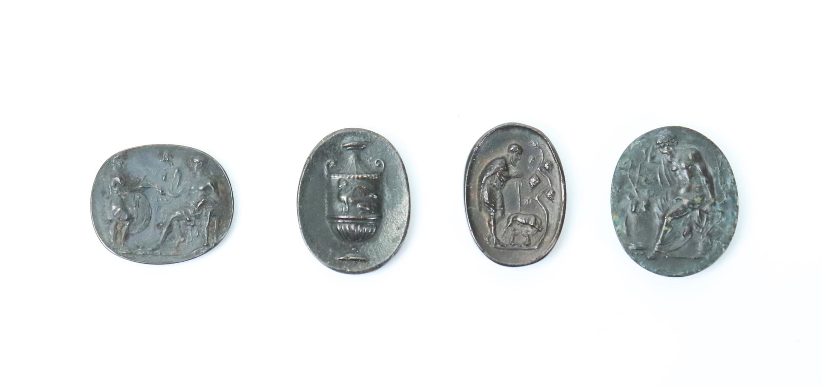 4 Rare Bronze Intaglio Tassie Gems ca 1800: 4 Rare Bronze Oval Intaglio Gems with polished flat backs attributed to the Tassie, Marchant, Brown workshops circa 1800: tentatively identified as: a 2 Handled Urn with Winged Sphinx to side, Faustul