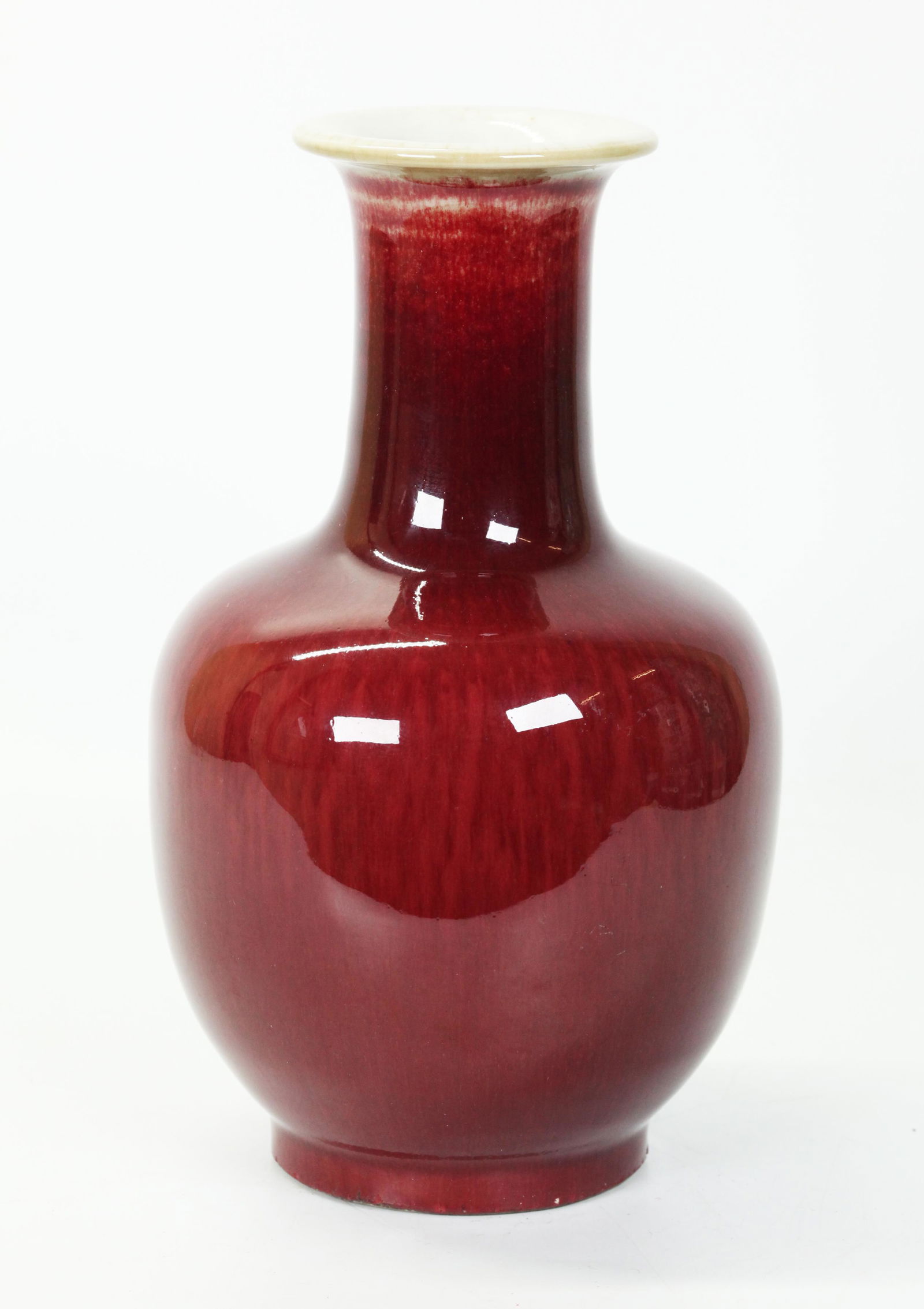 Chinese Underglaze Red Crackle Porcelain Vase: Chinese Underglaze Red Crackle Porcelain Vase, the red draining from the mouth to a pale celadon and with some over-flow to unglazed foot ring; the inside and base in clear crackle. Height 7 3/4 inche