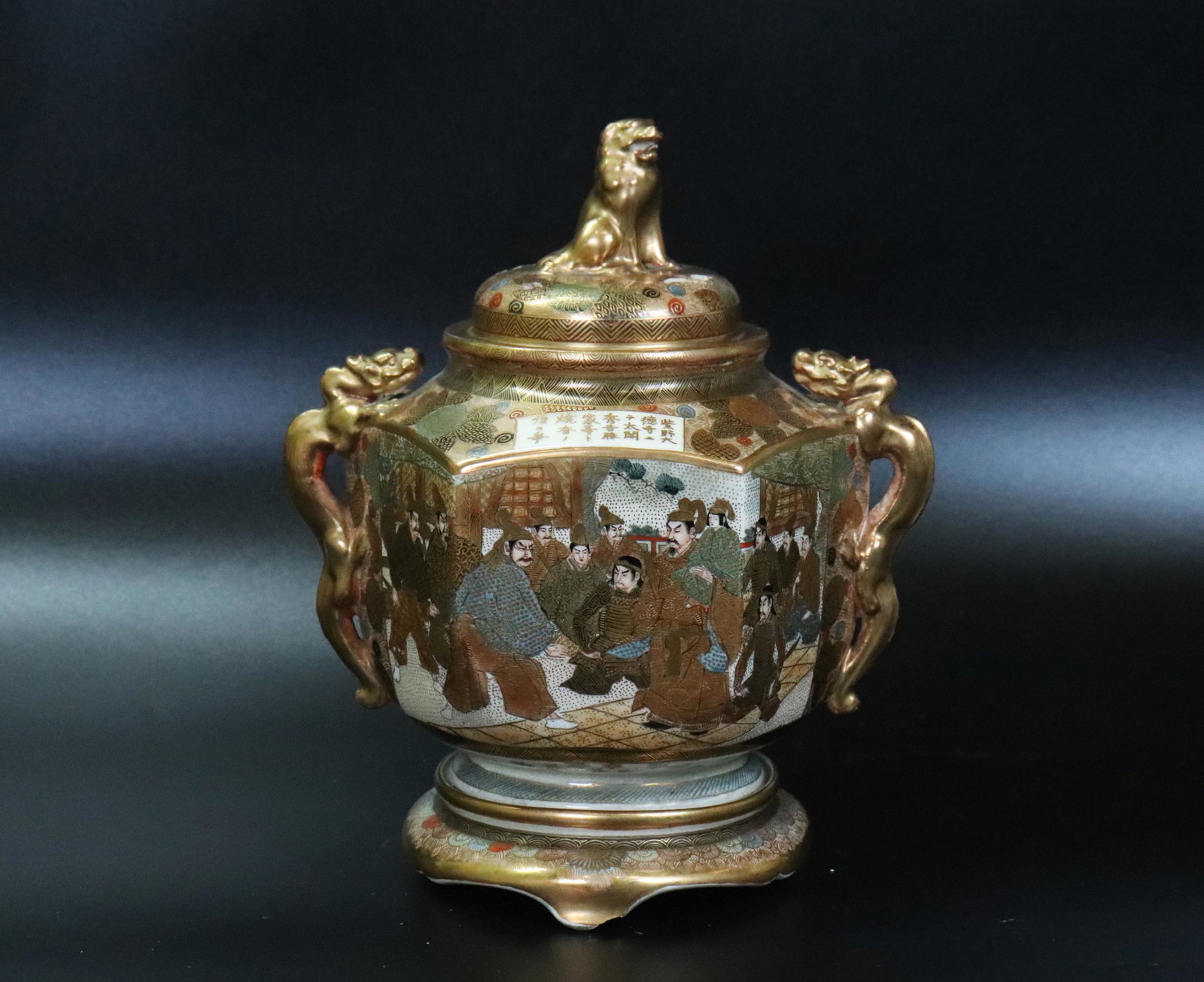 Japanese Satsuma Samurai Scene Incense Burner: Japanese Satsuma hexagonal Incense Burner with gilt Dragon handles to sides, mounted to a Satsuma 3 legged base and with a round pierced cover with gilt Shishi finial, all in colors and heavy with fla