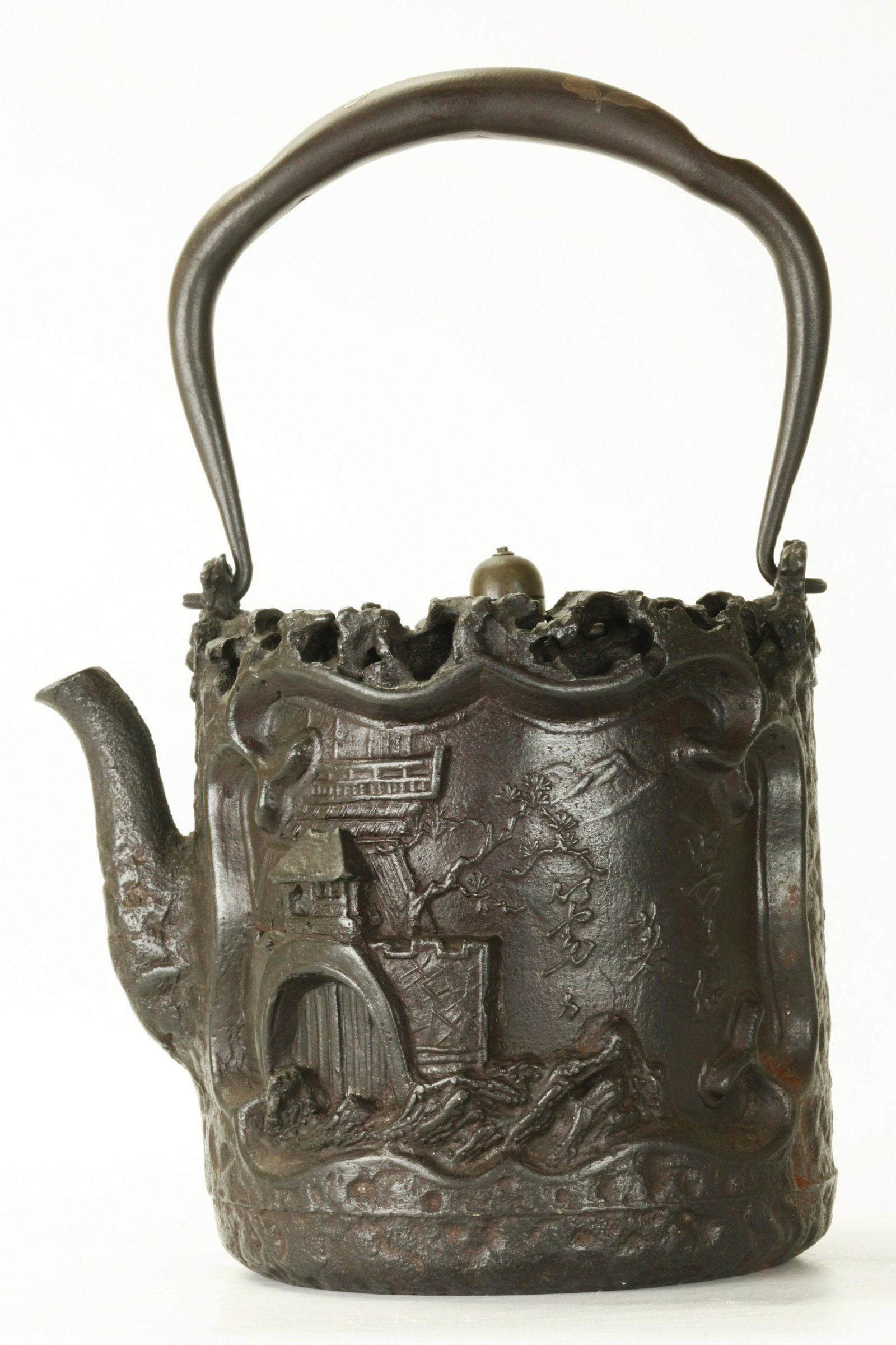 Da Guo Zao; Japanese Cast Iron Tetsubin Teapot: Da Guo Zao; Fine Japanese Cast Iron Tetsubin Teapot well designed with a figure at a scholar's table in high relief to one side, the reverse with a walled compound with cast inscription, another inscr