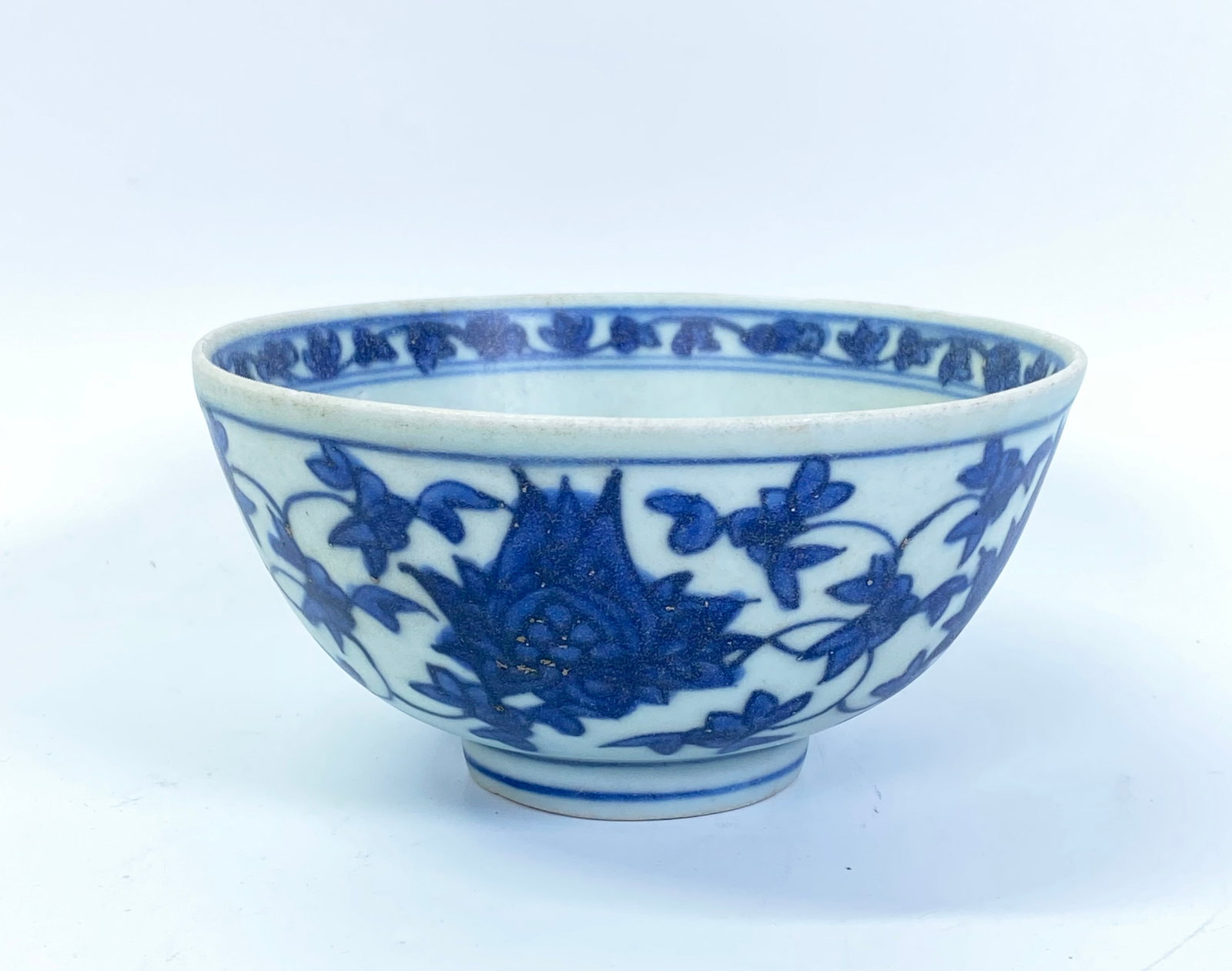 Chinese Blue & White Porcelain Lotus Bowl: Chinese Blue & White Porcelain Lotus Bowl with scrolling flowers and leaves to outside, a white flower & leaves on blue to round center with a scrolling floral band at mouth, the base with a rectangul