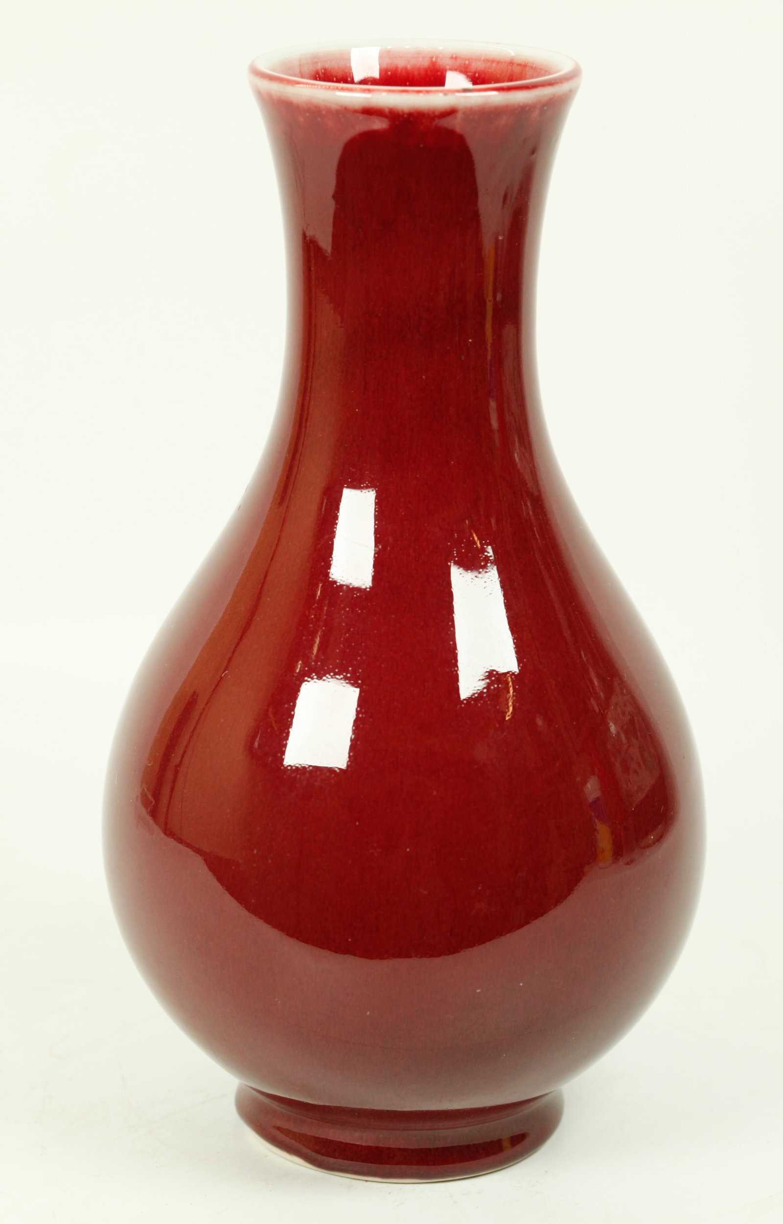 Chinese Underglaze Red Crackle Porcelain Vase: Chinese Underglaze Red Crackle Porcelain Vase, the glaze thinning at the mouth forming a pale celadon line with even glaze flow short of unglazed foot ring, the base in clear glaze. Height 9 3/4 inche