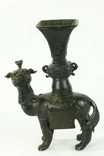Rare Chinese Ming Bronze Qilin & Gu Vase: Rare Chinese Ming Dynasty Bronze Qilin standing on 4 feet with an incised saddle blanket holding a 4 sided Gu Vase with curled handles on its back. Height 7 1/8 inches (18 cm.).