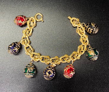 Italian 14K Yellow Gold Enamel Egg Charm Bracelet: Italian 14K Yellow Gold & 7 Enamel Zodiac & Sun Face Egg Charm Bracelet marked "Italy / 14K". Total weight 28.8 grams. Length 7 1/4 inches (18.4 cm.).