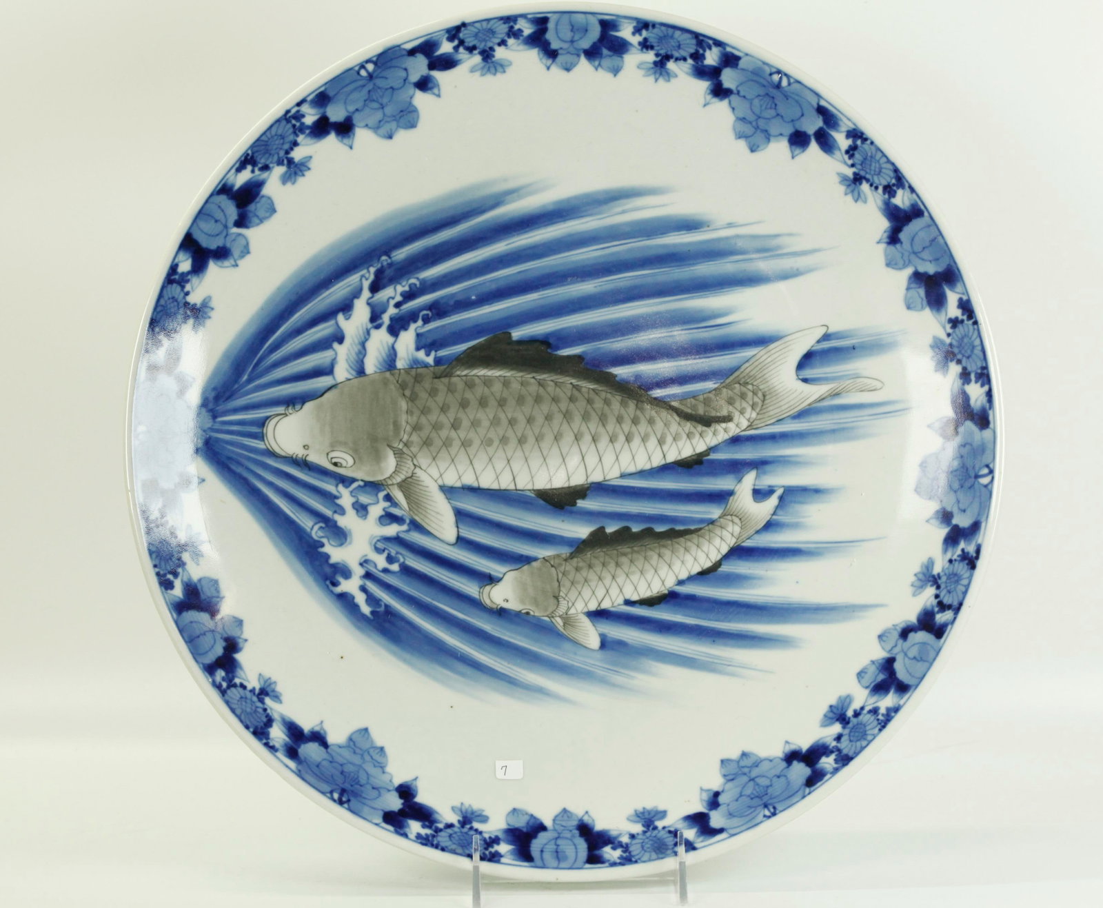Japanese 19 C Blue White Arita Porcelain Charger: Large Japanese 19th Century Blue & White Arita Porcelain Charger with a design of Father & Son Fish in Gray over underglaze blue Waves in Rushing Water with Blue Floral border to outside edge; the rev