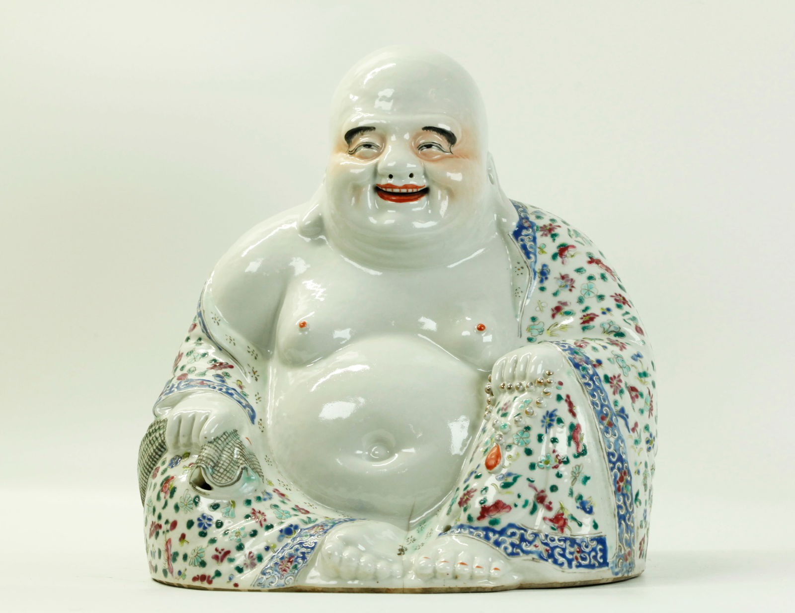Wei Hong Tai Zao Chinese Porcelain Budai Buddha: Chinese Enameled Porcelain seated Budai Buddha with sack & rosary, his robes covered in flower sprigs on a white ground, the unglazed flat base impressed with seal, Wei Hong Tai Zao. Height 10 1/4 inc