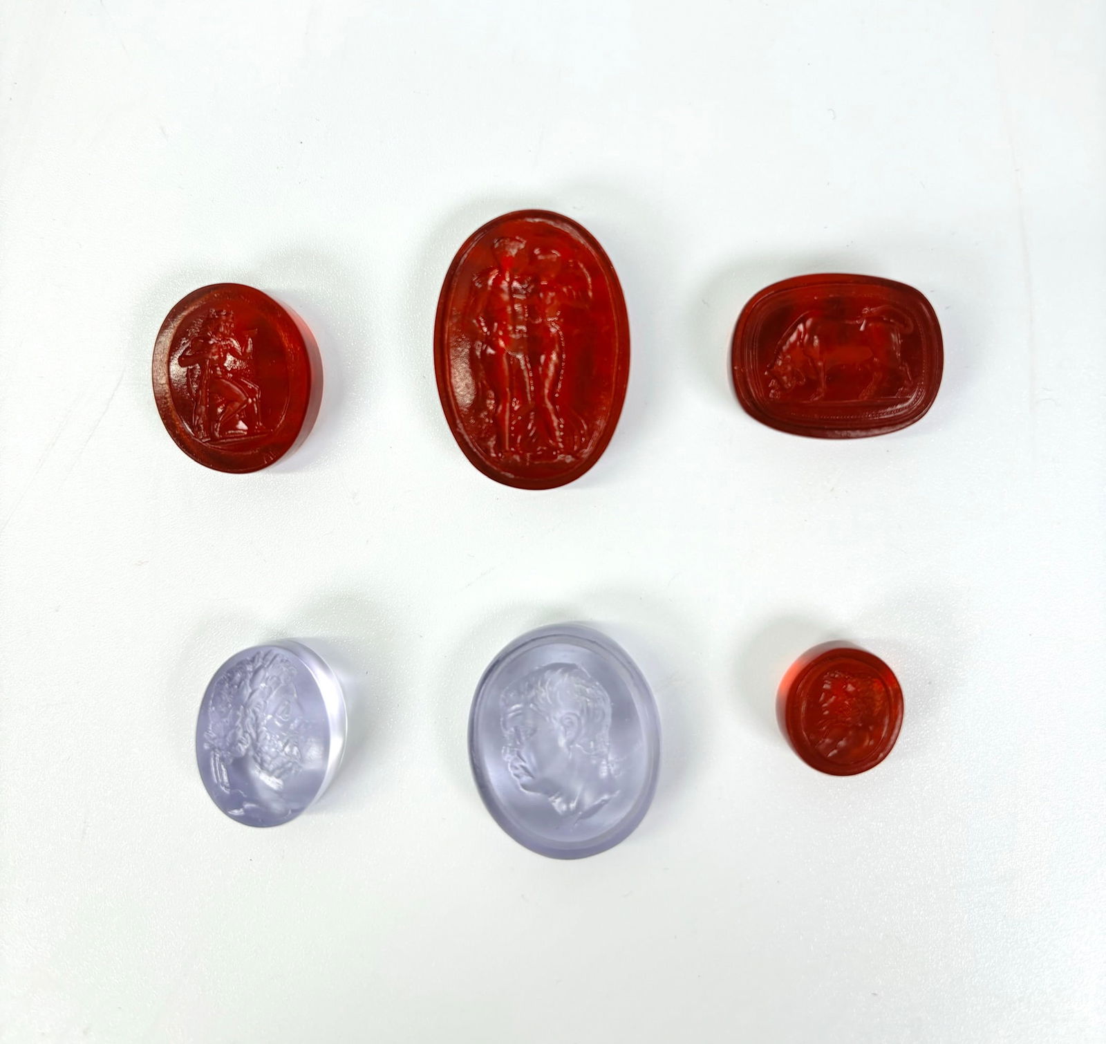 6 Tassie Glass Paste Intaglio Gems, 18th/19th C: 6 James Tassie or Tassie-Type Glass Paste Intaglios, 18th/19th Century with polished backs and sides; the largest in amber glass with standing nude Apollo and part-draped Venus, a pale amethyst glass