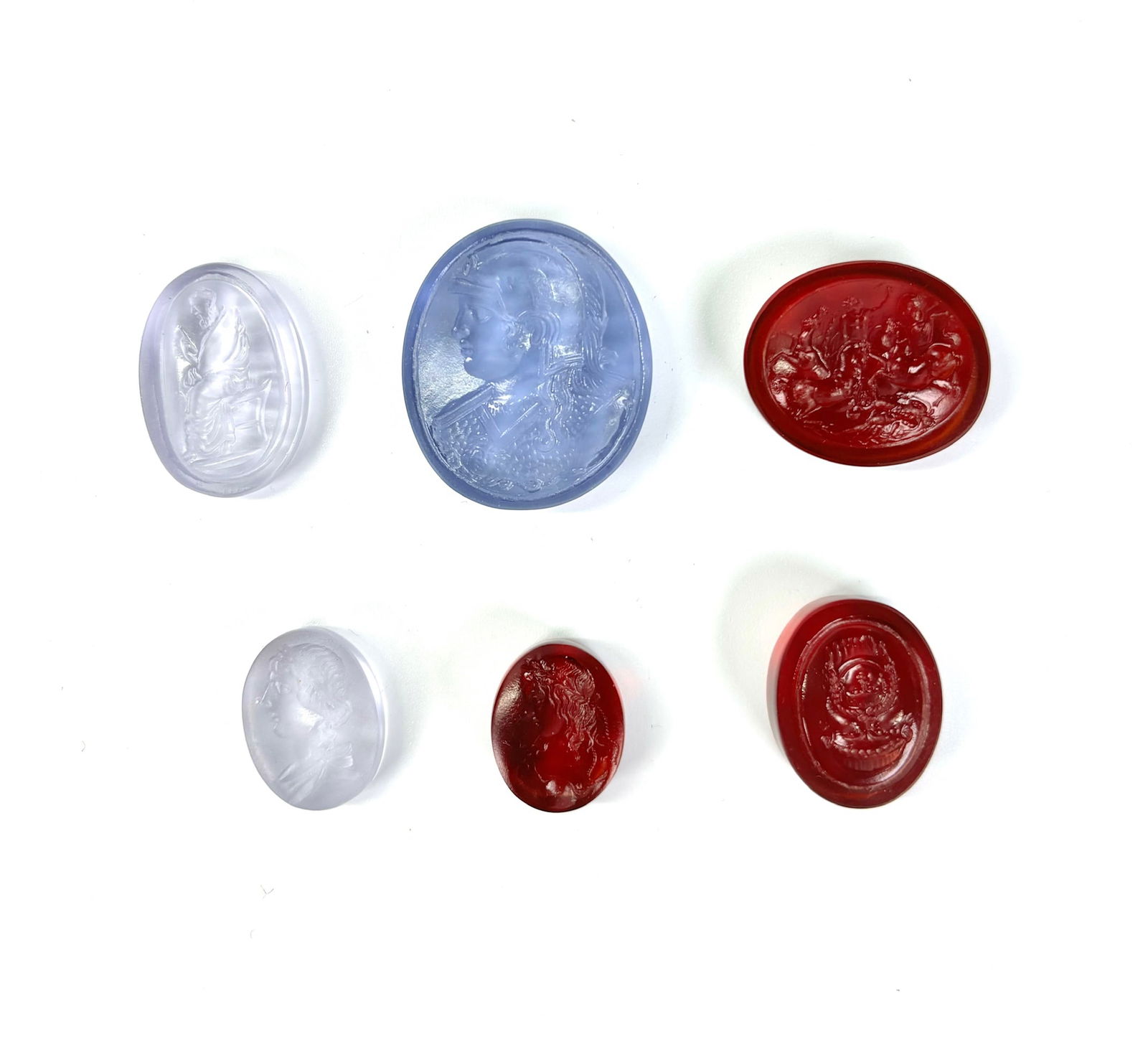 6 Tassie Glass Paste Intaglio Gems, 18th/19th C: 6 James Tassie or Tassie-Type Glass Paste Intaglios, 18th/19th Century with polished backs and sides; the largest in pale amethyst glass with Profile & Shoulder of a Warrior in elaborate Helmet and Bo