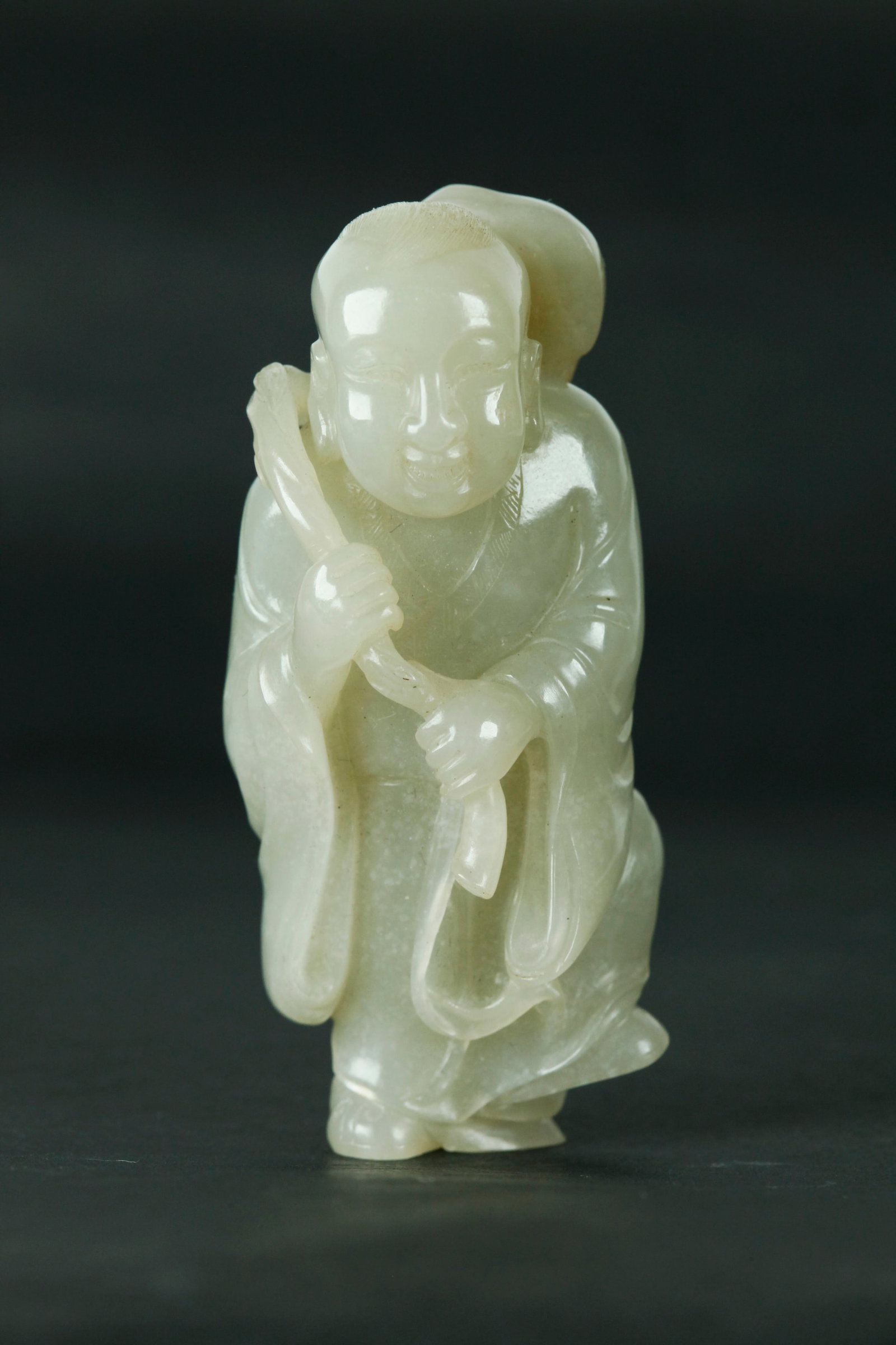 Fine Chinese 18th C White Jade Boy & Lingzhi: Fine Chinese 18th Century warm White Jade Dancing Boy balancing on his right foot and holding a lingzhi stem over his right shoulder carved from a light russet inclusion; with fine details to Lingzhi,