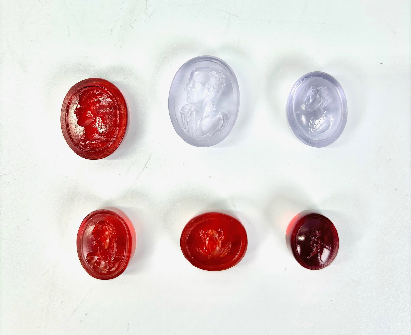 6 Tassie 18th/19th C Glass Paste Intaglio Gems: 6 James Tassie or Tassie-Type Glass Paste Intaglios, 18th/19th Century with polished backs and sides; the largest in pale amethyst glass with Profile & Shoulder Portrait of a Philosopher with raised h