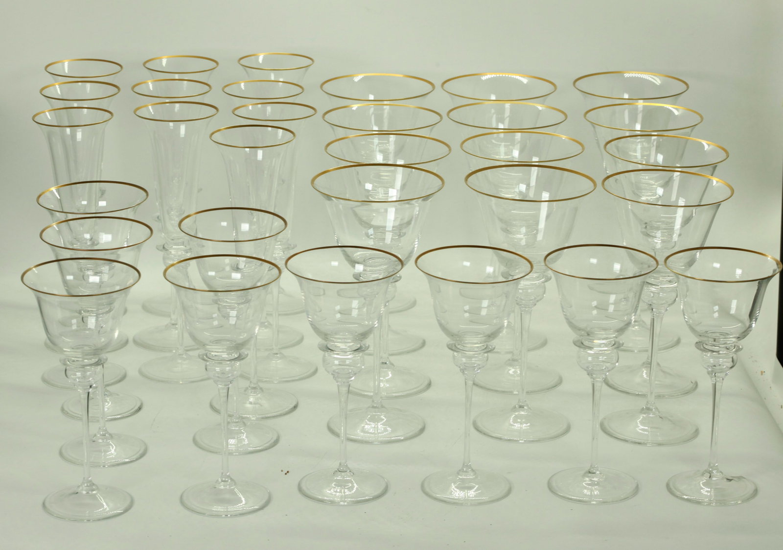 Gucci; Vintage Blown Crystal Glass with Gold Rims: Gucci; Vintage Blown Crystal Gasses in 3 sizes, the bowls with Gold Rims and with a large bubble at the tops of the high stems, the round bases acid etched GUCCI. See images. PROVENANCE: Fine furnishi