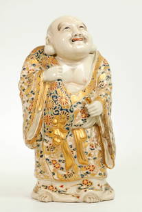 Japanese Satsuma Standing Hotei; Mark to Base: Japanese Satsuma crackle ceramic standing Hotei with sack over his right shoulder his robes with elaborate enamel and raised gold decoration ; iron red Mark to unglazed Base. Height 9 1/2 inches (24 c