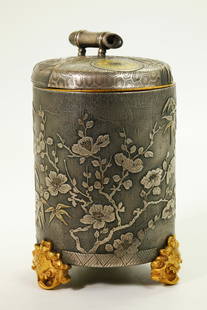 Japanese Silver & Gilt Bronze Cup Container: Japanese Silver & Gilt Bronze Cup Container, the sides cast with leaves and flowers over 3 gilt mask feet, the cover with a cash-coin and bambooshaped handle. the inside with a removable gilt cup. Hei