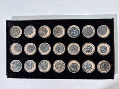 Collection 21 Greek or Roman Coins: Collection 21 Greek or Roman metal Coins each in round box set into display box. Most coins show metal decay. Approximate diameter of larger coins 1 1/4 inches (3.1 cm.).