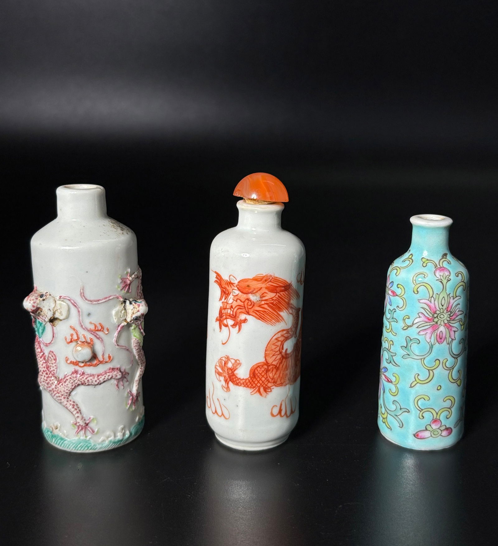 3 Chinese Enameled Porcelain Tube Snuff Bottles: 3 Chinese enameled Porcelain tubular snuff bottles: a bottle with 2 applied Dragons either side of an applied flaming pearl over waves, the base with 4 character Daoguang mark in underglaze blue; a bo