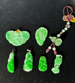 7 Chinese Pale to Dark Green Jadeite Pendants