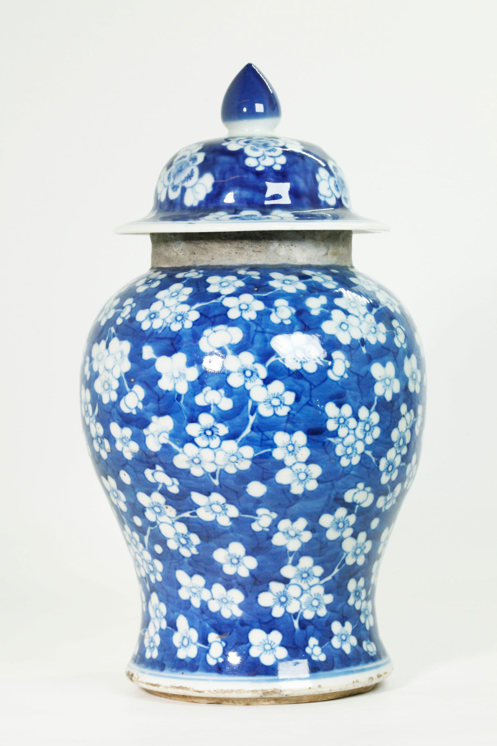 Chinese Blue White Porcelain Prunus Jar & A Cover: Chinese Qing Dynasty Blue & White Porcelain Prunus Jar with unglazed neck and a very similar, well fitting Cover with blue finial. Height with cover 13 1/4 inches X diameter 6 1/2 inches.