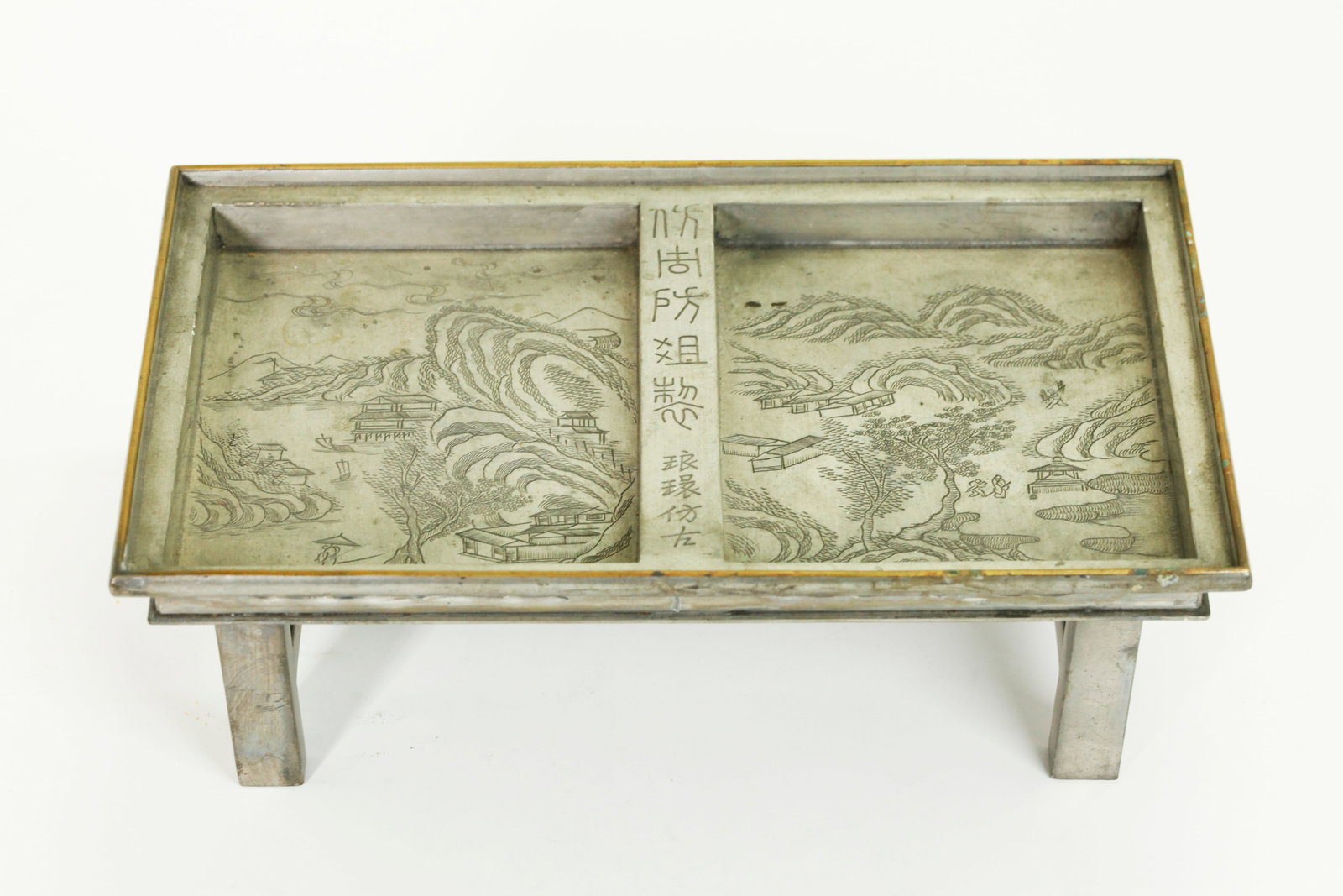 Chinese Qing Incised Pewter Mini Tea Tray Table: Chinese Qing Dynasty Landscape Incised Pewter Double Tea Tray on 4 high square tube legs forming a miniature table, bronze gallery edge at top; the base impressed with 2 seal marks. Height 3 3/8 inche