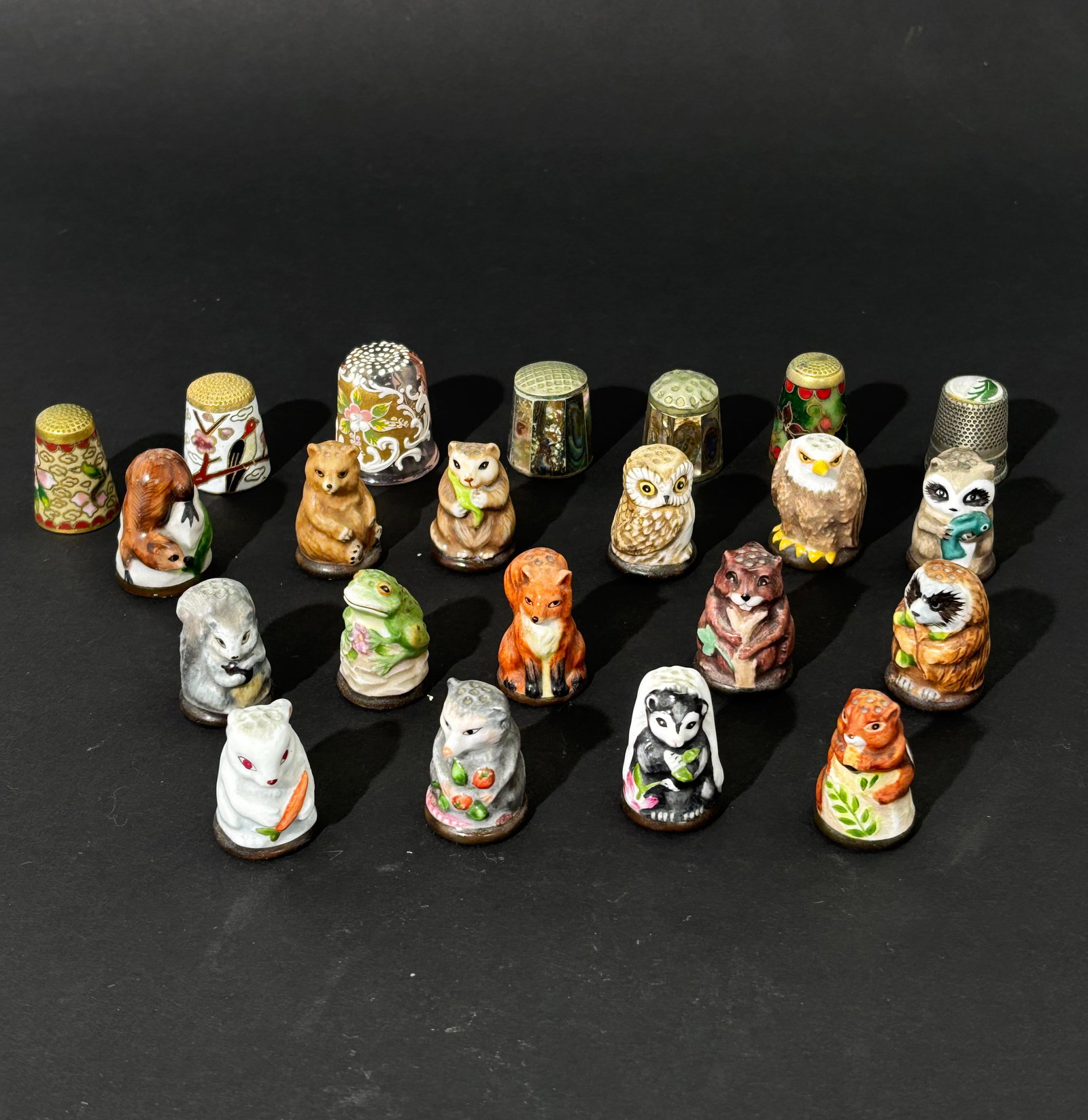 15 Friends Of Forest Thimbles; + 7 Assorted: 15 Friends Of The Forest Porcelain Thimble Collection, each dated 1982; together with 3 Chinese cloisonne Thimbles, 2 abalone shell thimbles 1 Treasured Keepsake Thimble and 1 enameled glass thimble.