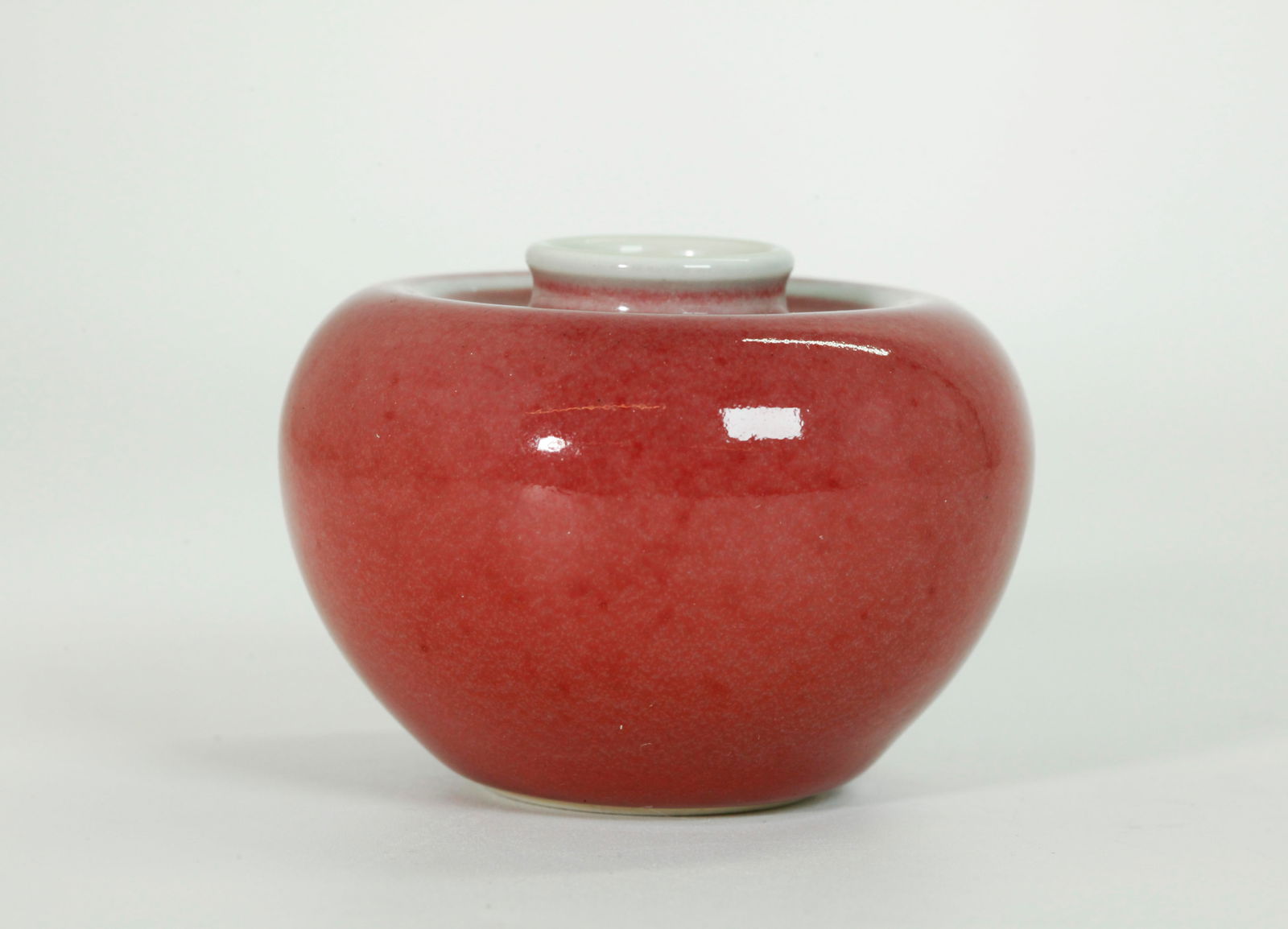 Chinese "Apple" Shaped Peachbloom Porcelain Pot: Chinese "Apple" Shaped Peachbloom Porcelain Water Pot; the inside and base in clear glaze with a 6 character Kangxi mark to bottom in underglaze blue. Height 2 1/4 inches X diameter 3 1/8 inches.