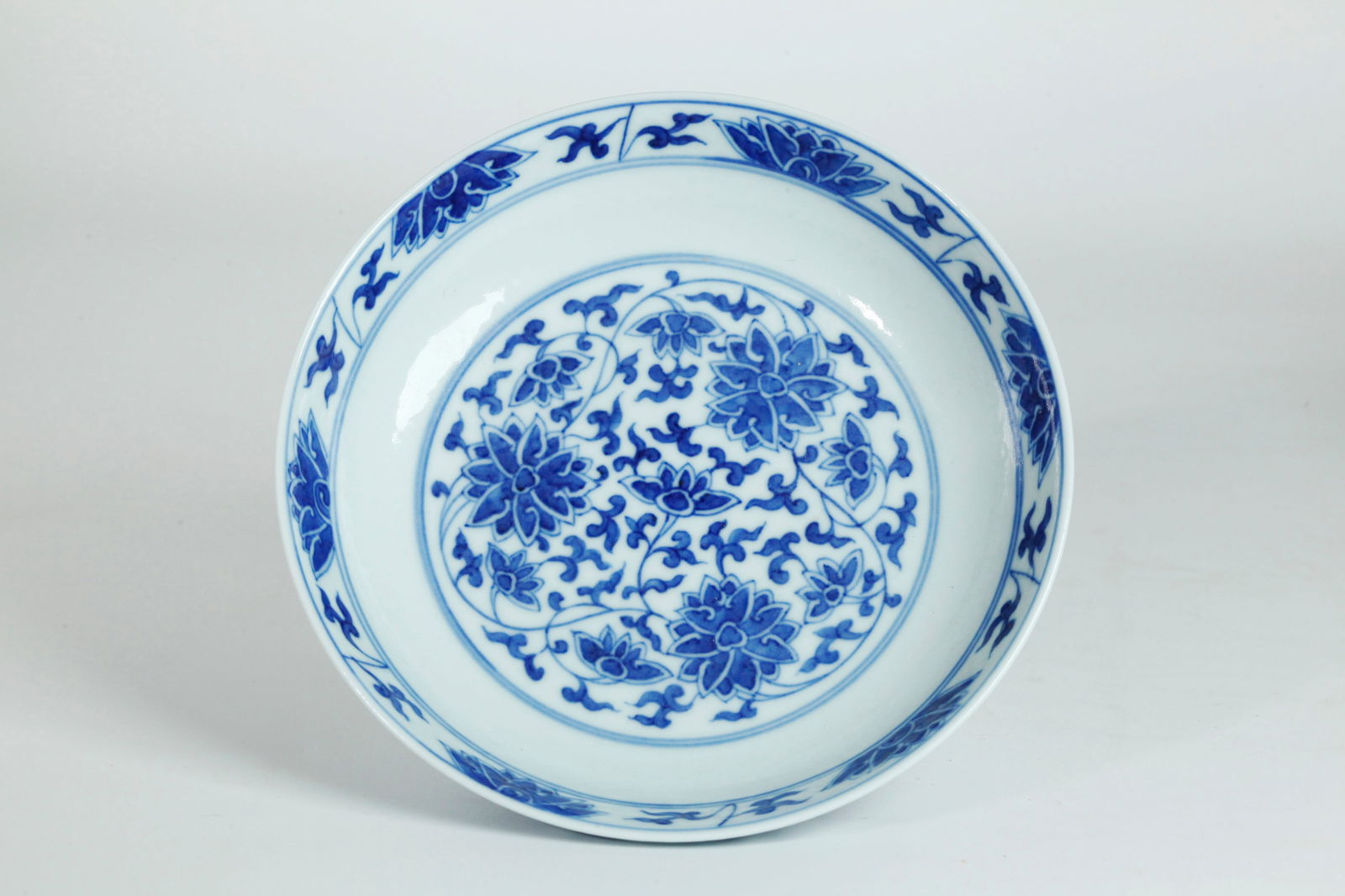 Chinese Blue White Porcelain Lotus Guangxu Plate: Chinese Blue White Porcelain Lotus small Plate, the recessed base in clear glaze with 6 character Guangxu mark in underglaze blue and of the period. Diameter 6 1/8 inches X height 1 3/8 inches.
