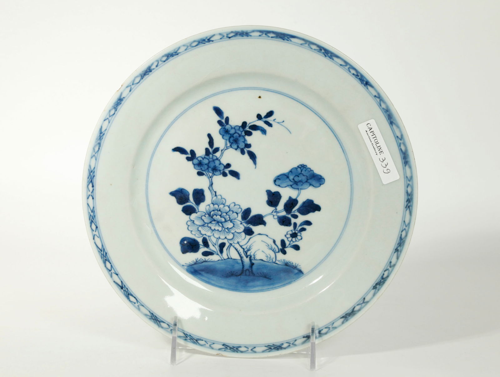Chinese 18th C Export Blue & White Porcelain Plate: Chinese 18th Century Export Blue & White Porcelain Plate with a center design of a hill and Garden Rock with Flowers and a simple outside ribbon border; the reverse in clear glaze. Diameter 9 inches X