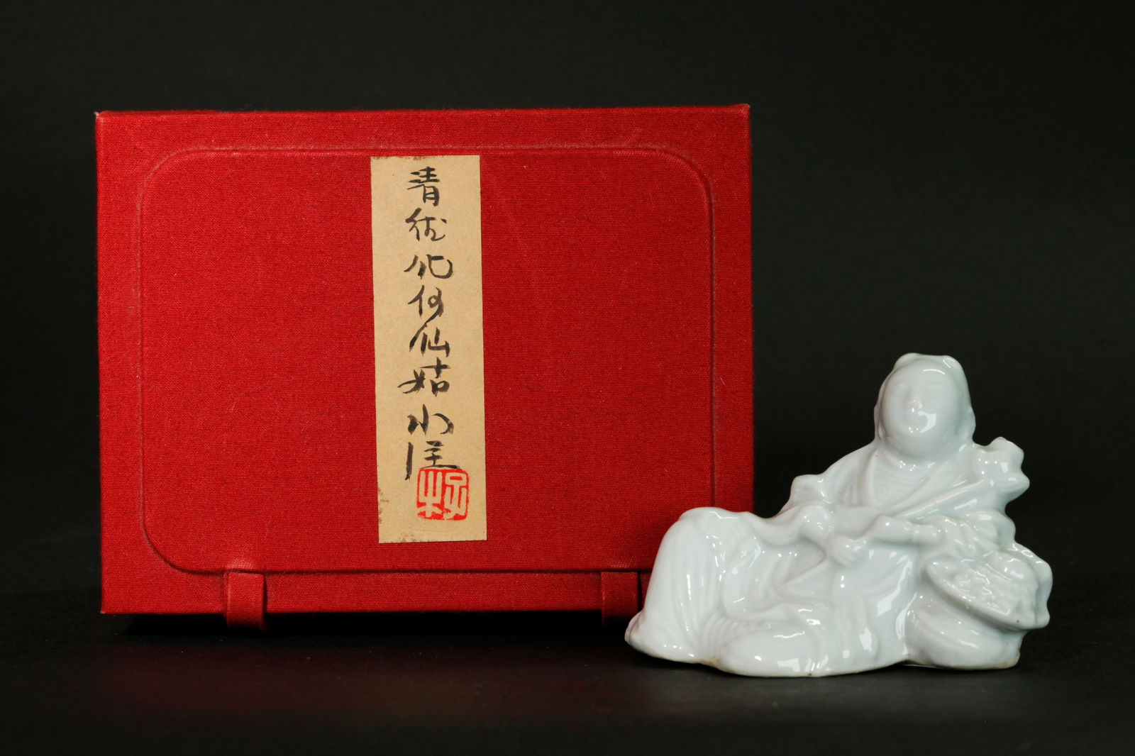 Chinese 18 C Blanc De Chine Water Dropper: Chinese 18th Century Blanc De Chine Dehua Porcelain Water Dropper molded and detailed as the Immortal Lan Caihe reclining on a basket of flowers and holding a Lotus Blossom Stem forming the spout with