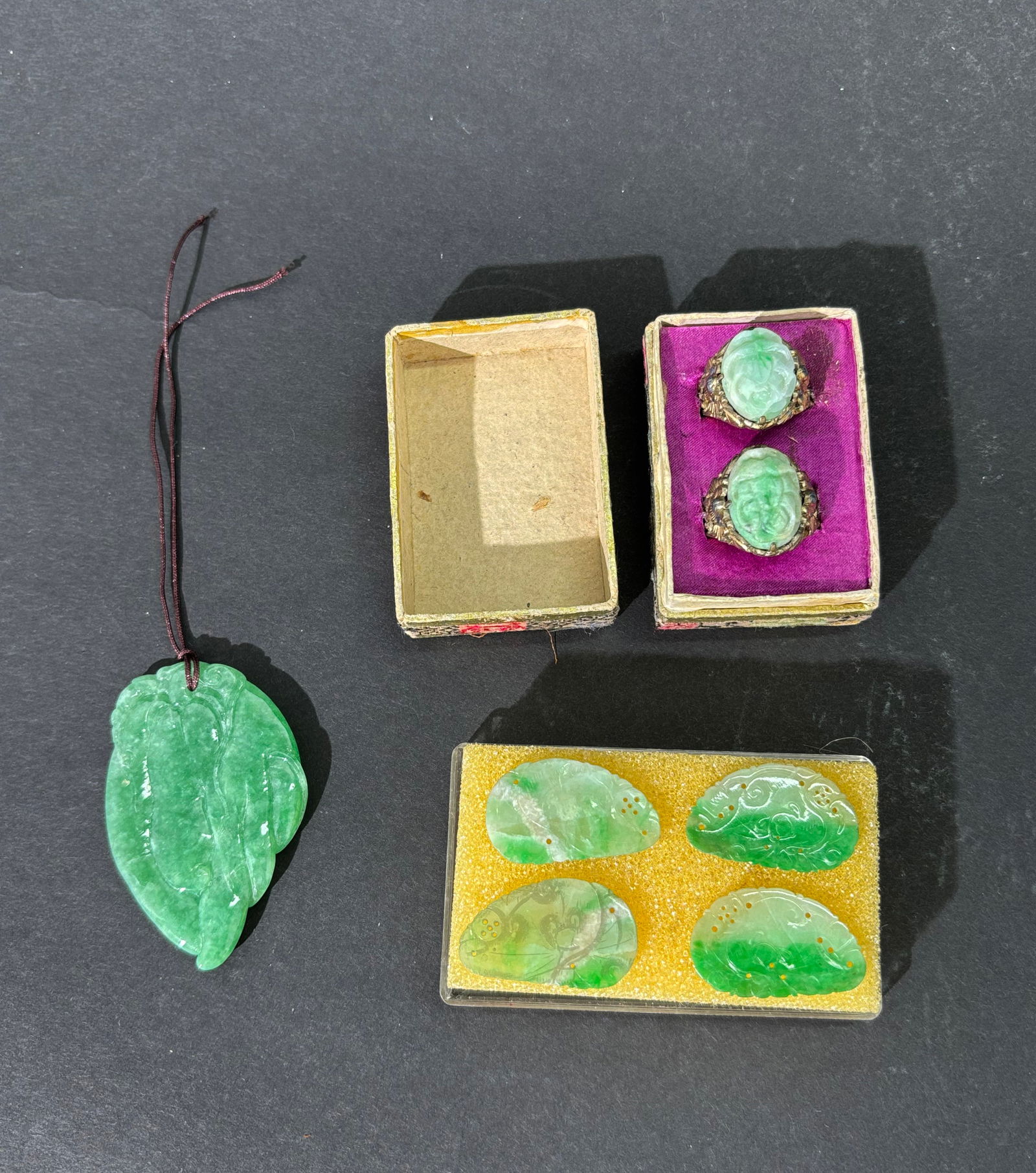 7 Chinese Antique Jadeites; Rings Carvings Pendant: 7 Chinese Antique Jadeites; 2 Rings with 19th Century Apple Green Jadeite ovals in adjustable gilt silver settings markede CHINA and in possibly original box; 4 white to apple green to green 19th Cent