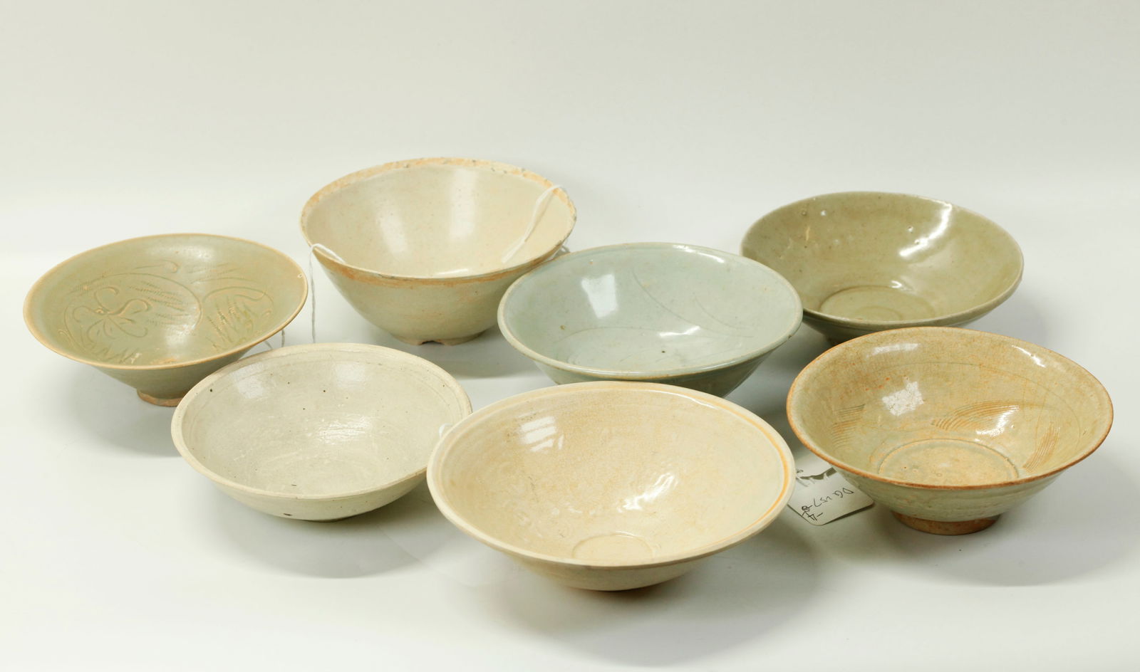 7 Chinese Song Qingbai & Celadon Porcelain Bowls: 7 Chinese Song Dynasty Qingbai and/or Celadon Porcelain Bowls apparently from various different kilns and with molded or incised designs or left undecorated. Diameter of larger bowl 6 3/4 inches. NOTE