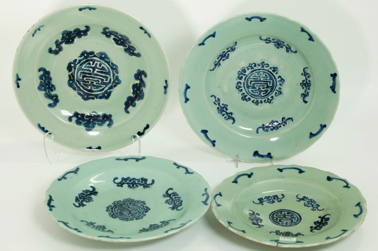 4 Chinese Blue White Celadon Porcelain Shou Plates: Chinese Blue White Celadon Porcelain Plates, the surfaces painted in blue on white slip with Shou Roundels with Ruyi Head border to centers each surrounded by 5 bat-like shapes, the bases of each with
