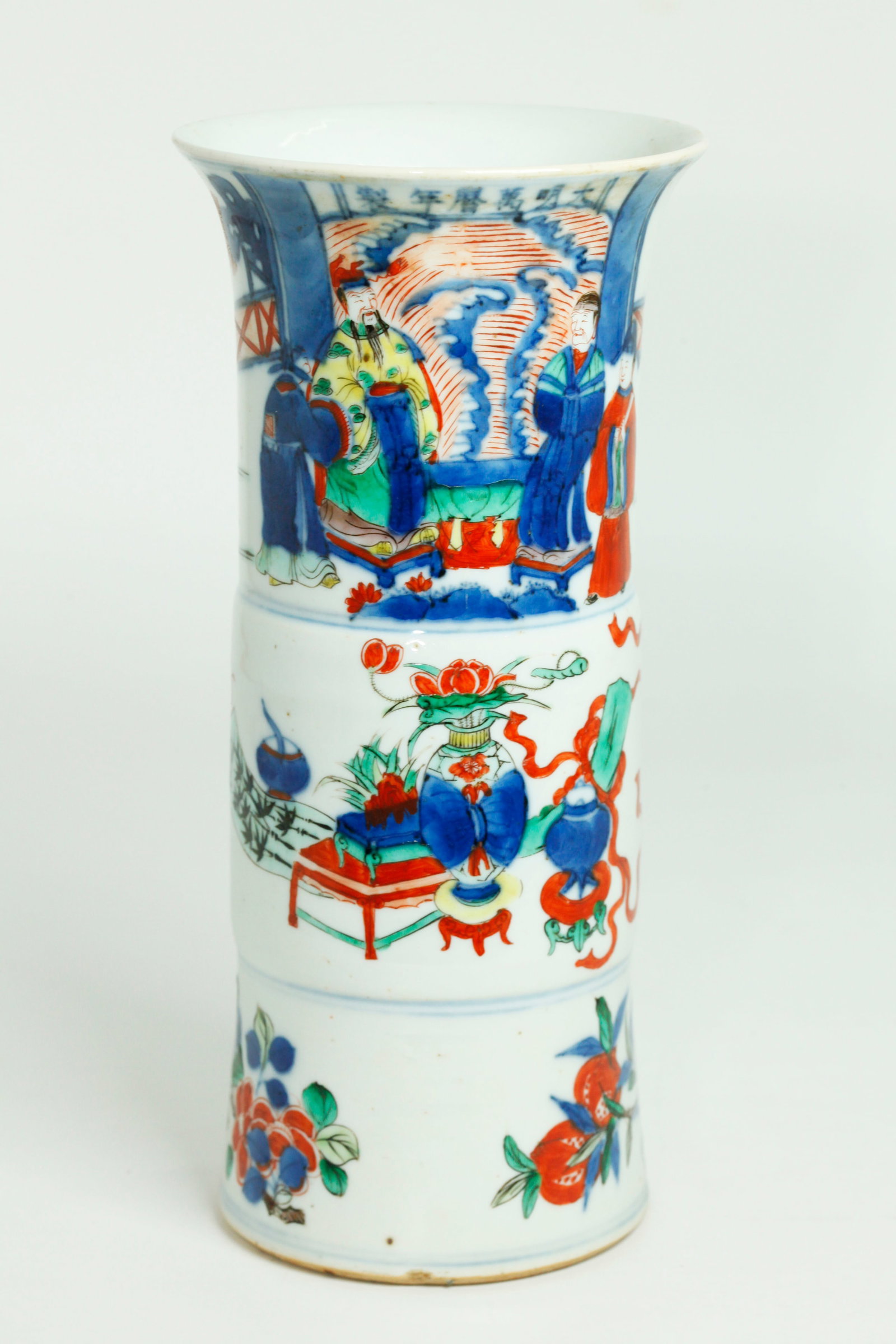 Chinese 19th C Wucai Enameled Porcelain Gu Vase: Chinese 19th C Wucai Enameled Porcelain Gu Vase, the bottom with fruit & flowers, the middle with Auspicious Objects and the flared mouth with Family paying homage to a seated Dignitary in yellow with