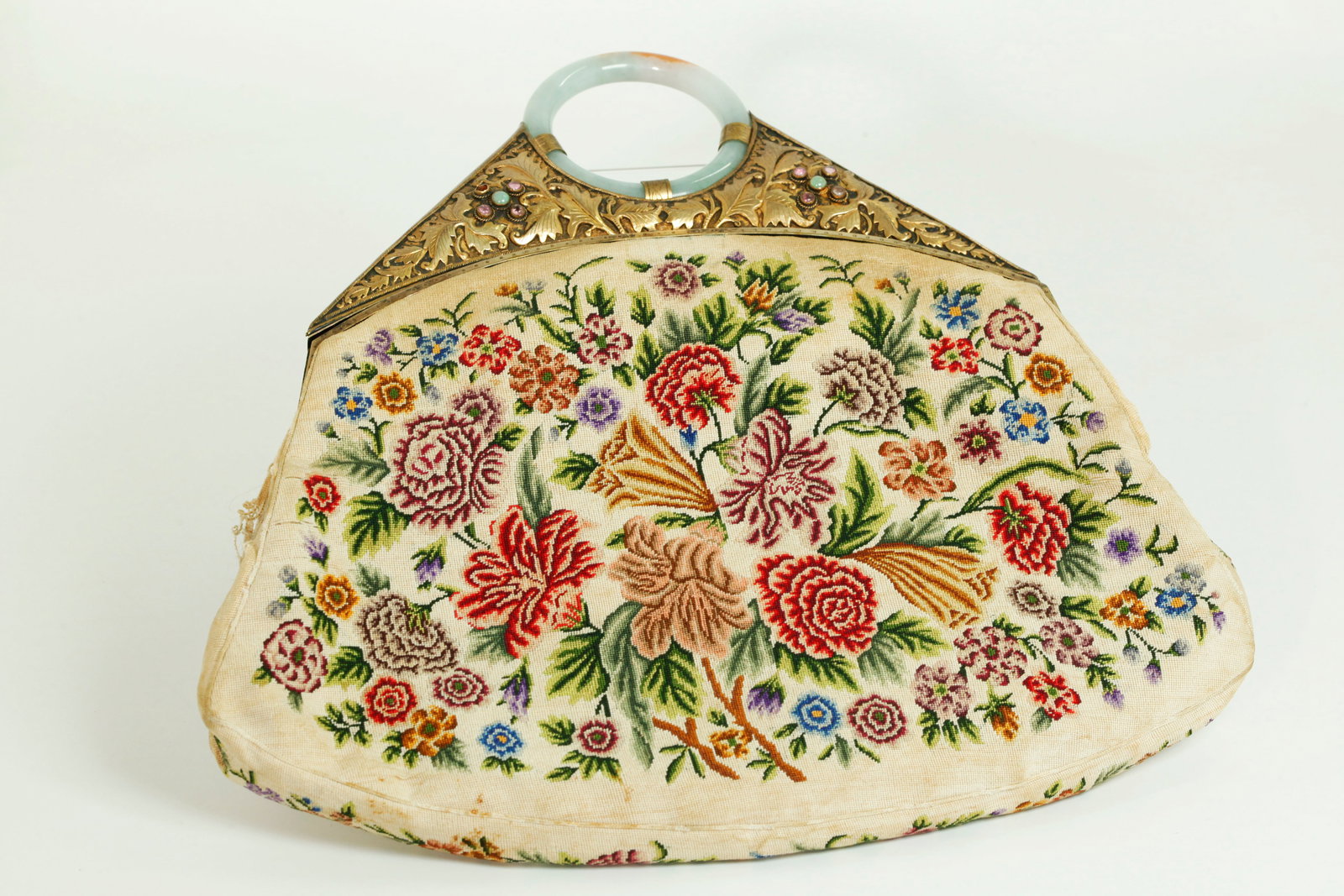 Vintage Chinese Petit Point Bronze Jadeite Handbag: Vintage Chinese Silk Floral Petit Point on a Cream Ground Handbag with a gilt bronze hinged closure set with small tourmalines or amethysts and 4 green jadeite round cabochons with a pale celadon & Ru