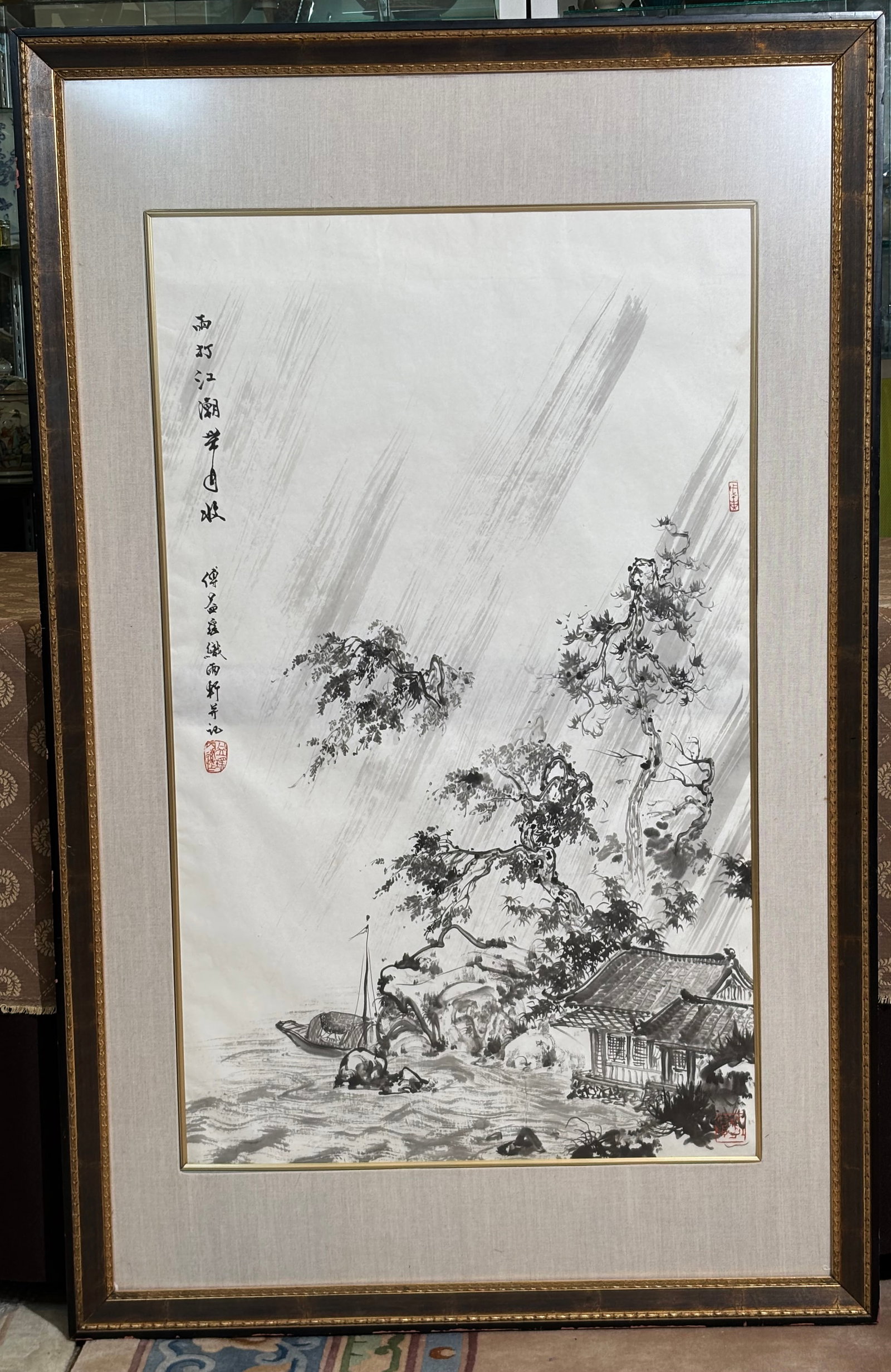 Fu Yi-Yao; Chinese Ink Painting Fishing Hut & Rain: Fu Yi-Yao; Chinese Ink Painting on paper of a Fishing Hut under trees with Boat in heavy Rain, with ink calligraphy and 3 red seals; fabric covered matting with gold bevel over the art and framed to e