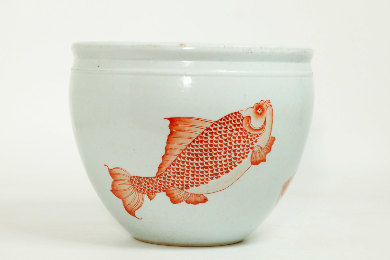Sm Chinese Porcelain Fish Bowl 3 Iron Red Fish: Small Chinese Porcelain Fish Bowl with rounded mouth, well enameled to the outside with 3 Iron Red Fish, the base slightly concave and unglazed. Height 7 1/4 inches X diameter 9 1/8 inches.